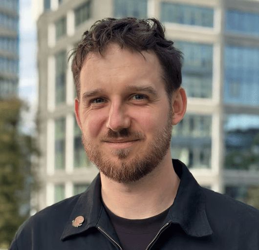 Karol Nowak desigener - picture posing on the comtemporary buisness district buildings background