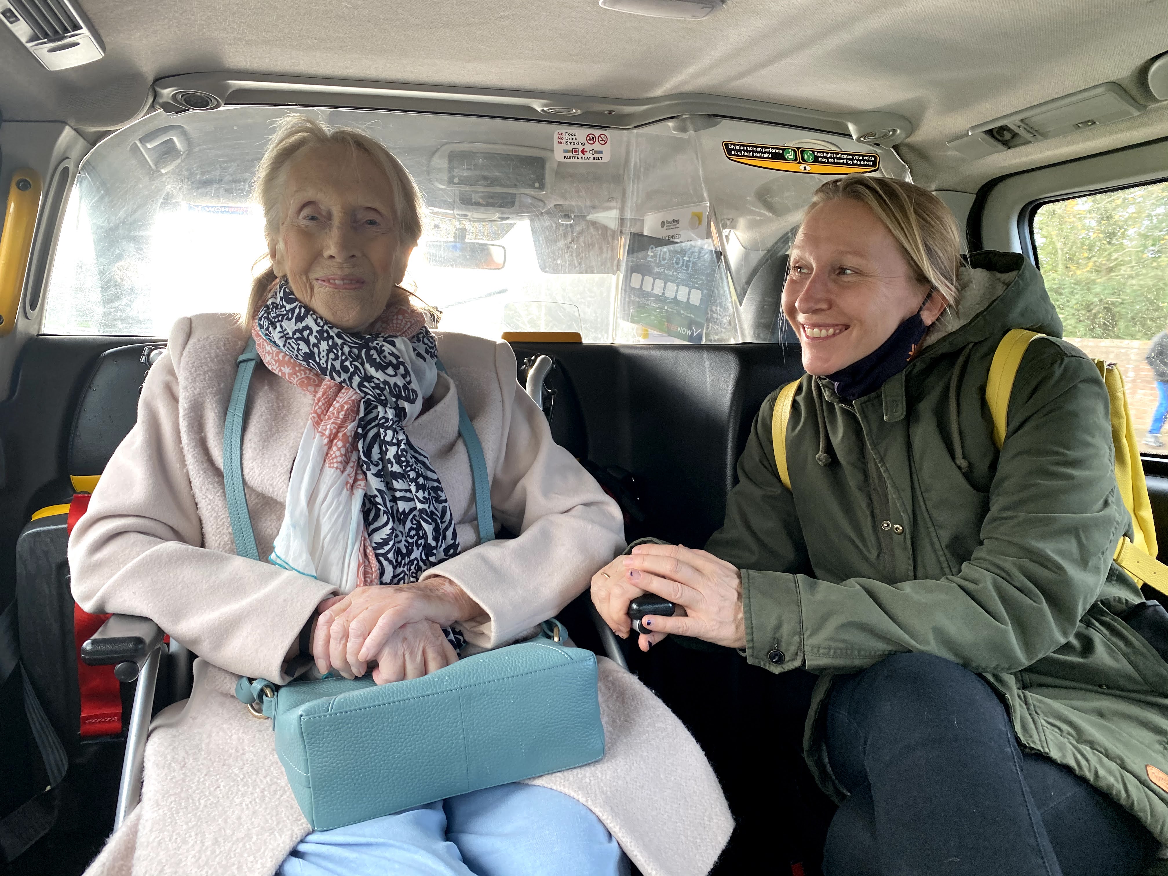 Heidi smiling in a taxi with her mum