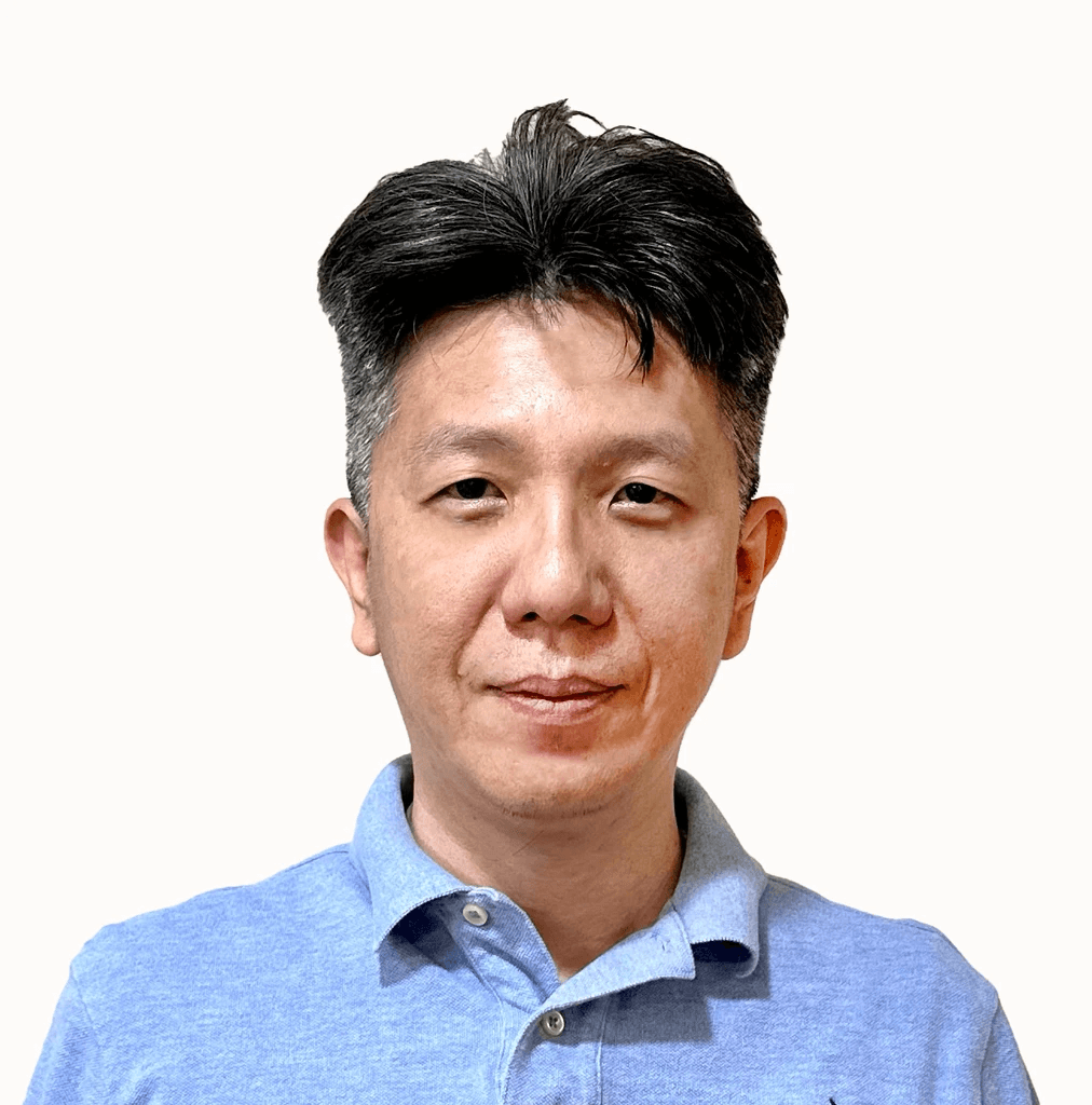 smiling man wearing black turtleneck shirt holding camrea