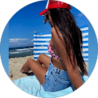 woman in black long sleeve shirt wearing white hat standing on green grass field during daytime