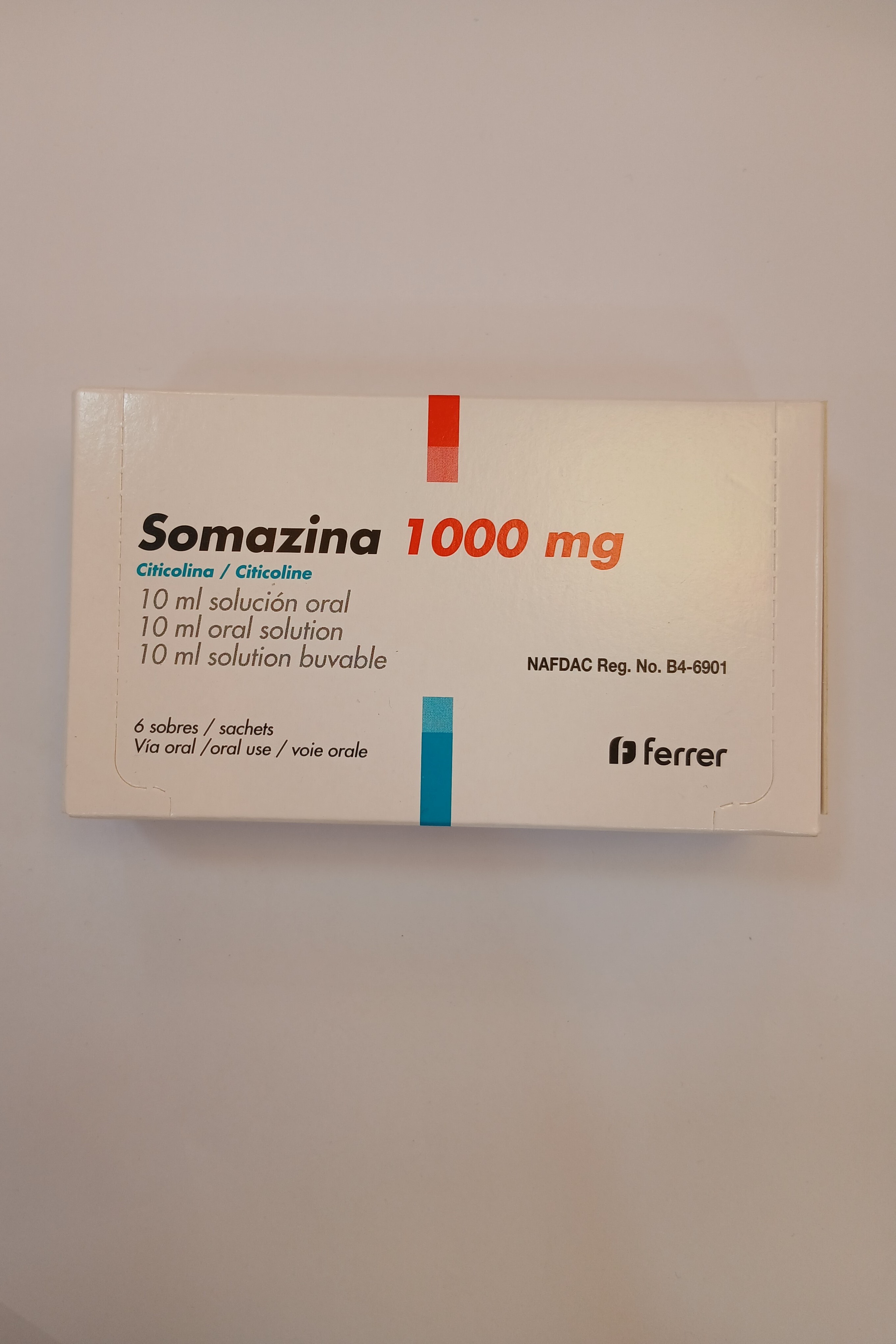 Somazina 1000 mg oral solution by Ferrer, 10 ml vial blister pack containing 10 single-dose ampoules in white and blue cardboard box.