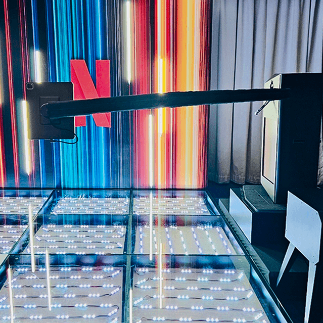 Minimalist brushed-steel chair in a white corner studio—industrial, brutalist modern furniture.