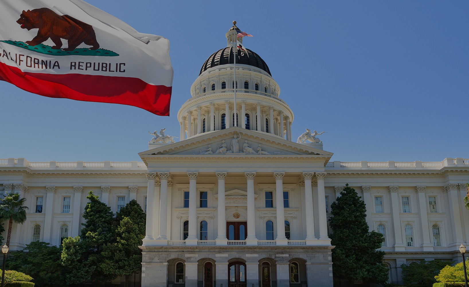 Cover image for Righetti Law featuring California State Capitol building with California Republic flag waving in the foreground under a clear blue sky.