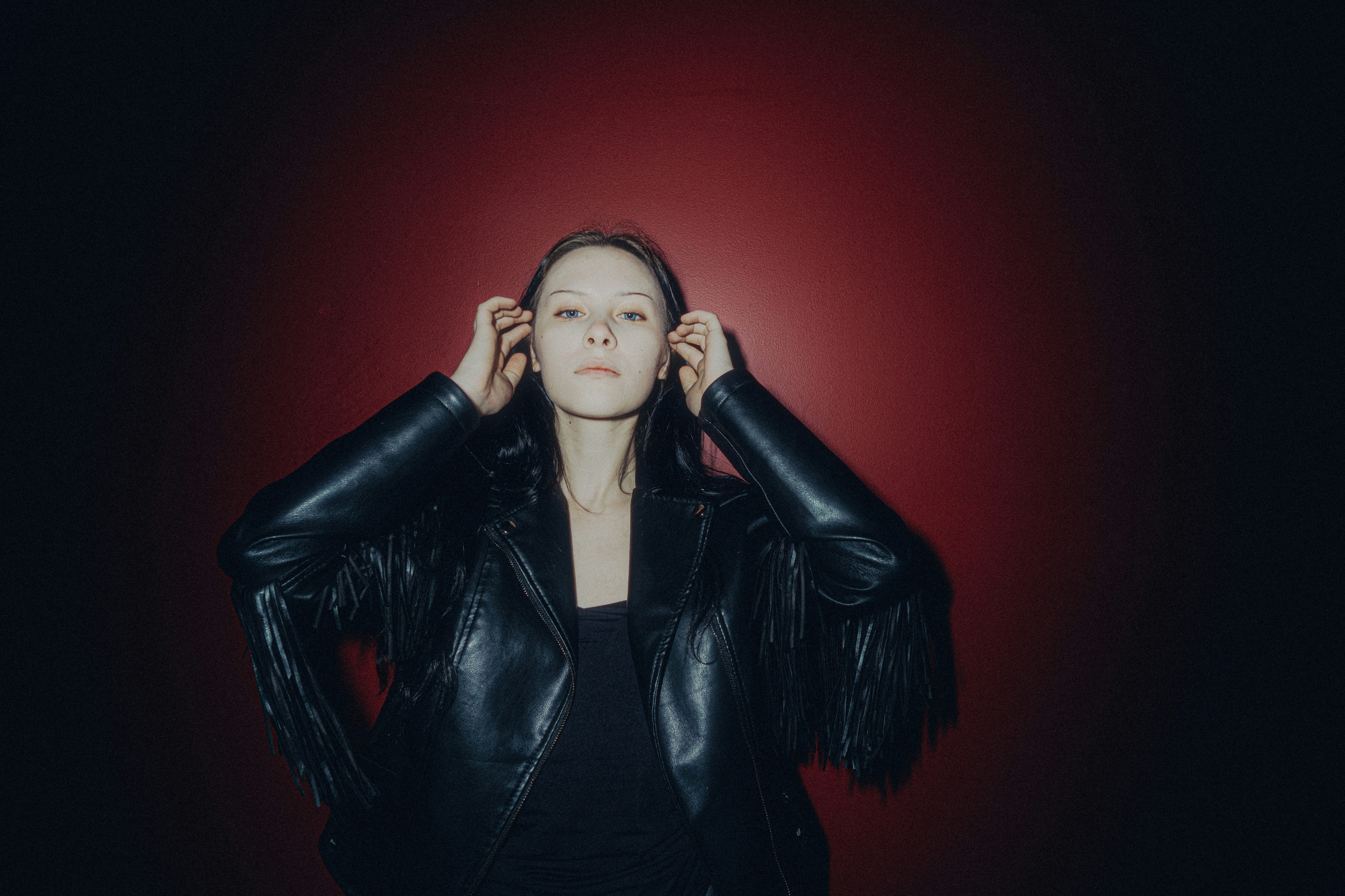 Woman in black leather jacket with fringe detail