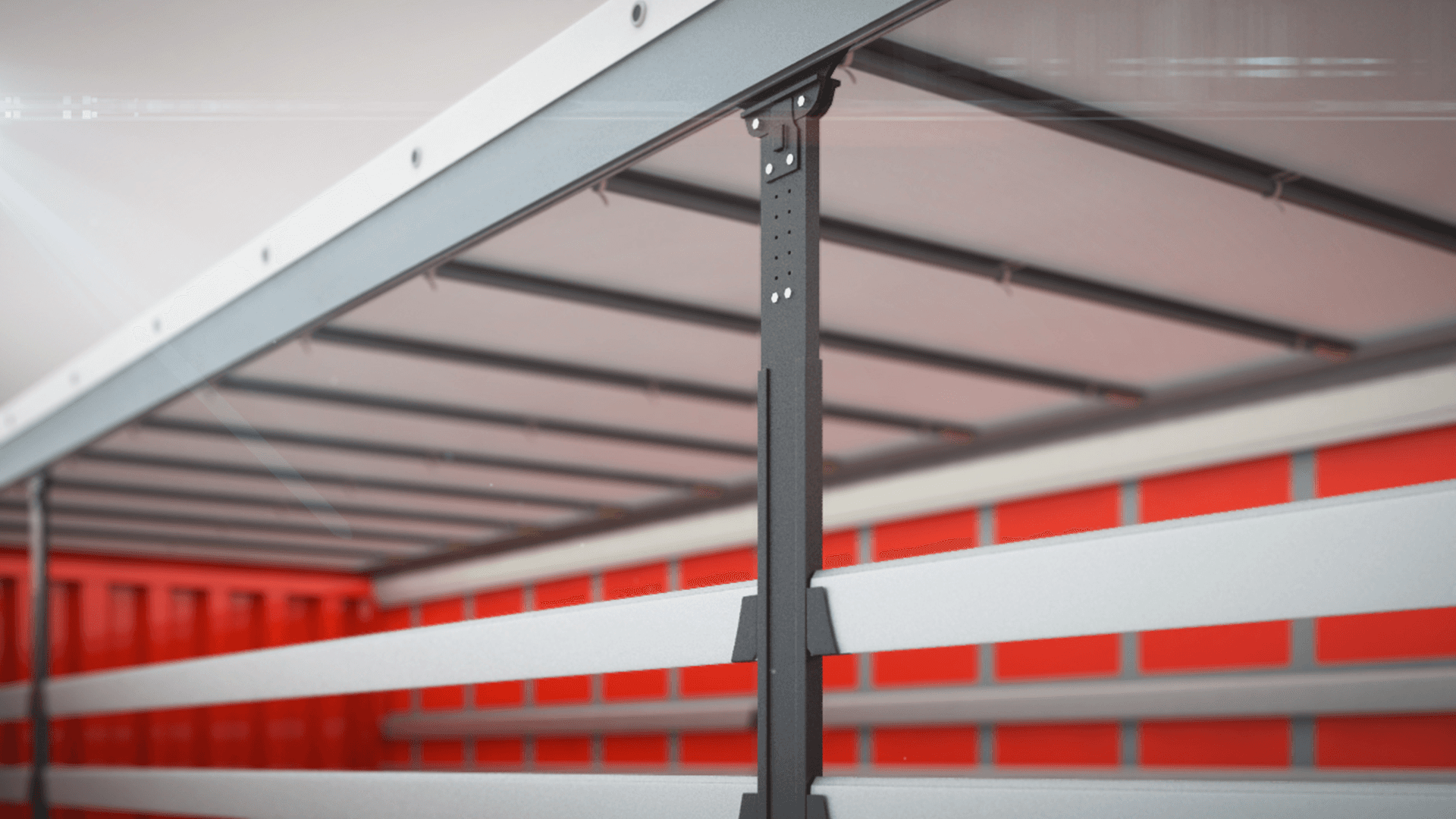 Wnętrze naczepy ciężarowej z widoczną konstrukcją wsporczą i szynami bocznymi w czerwono-białej kolorystyce, przygotowane do załadunku towaru.