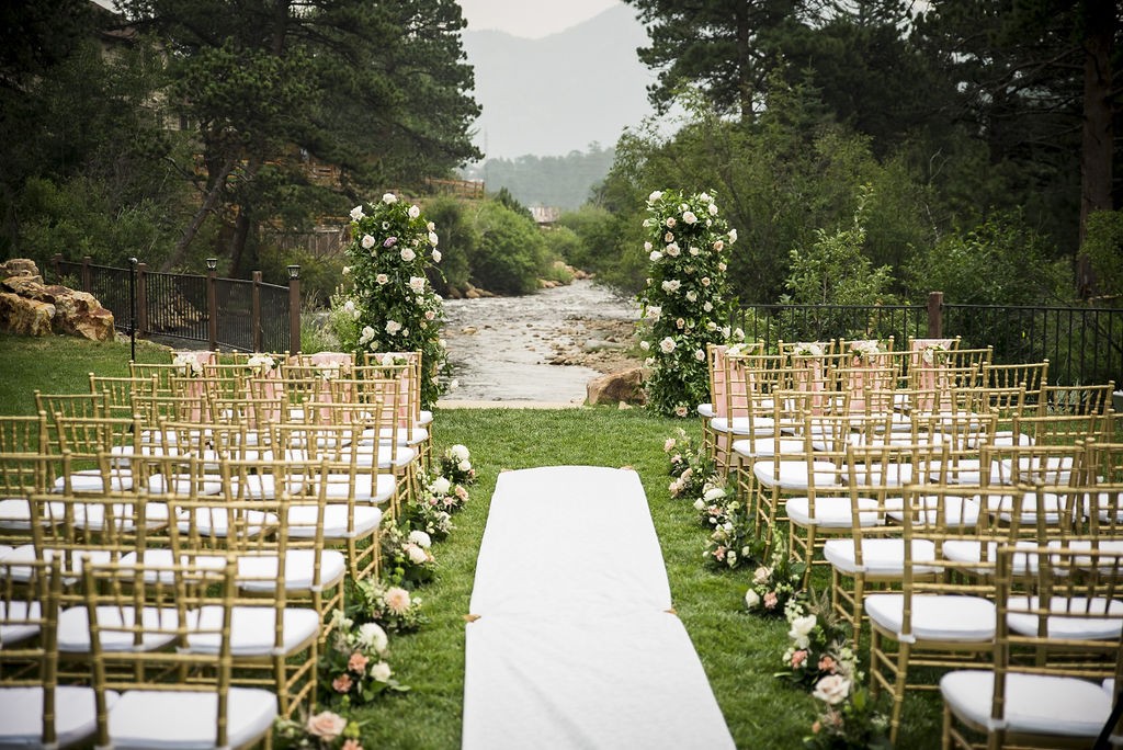 Outdoor wedding reception table set with natural linens and delicate flowers in garden setting
