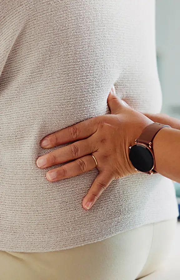 Chiropractor adjusting the lower back of a patient. 