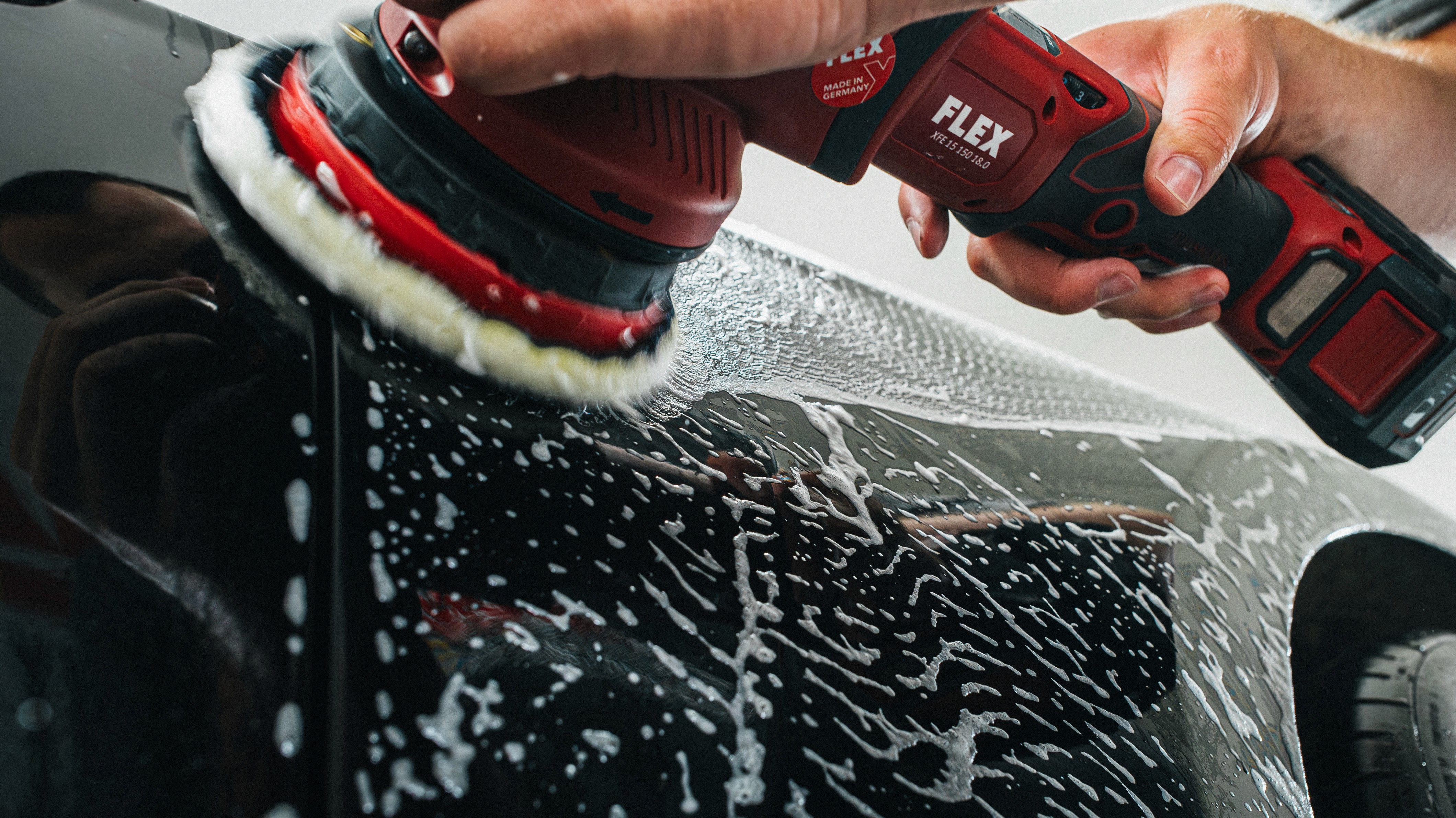 Close-up of white bicycle frame with a logo.