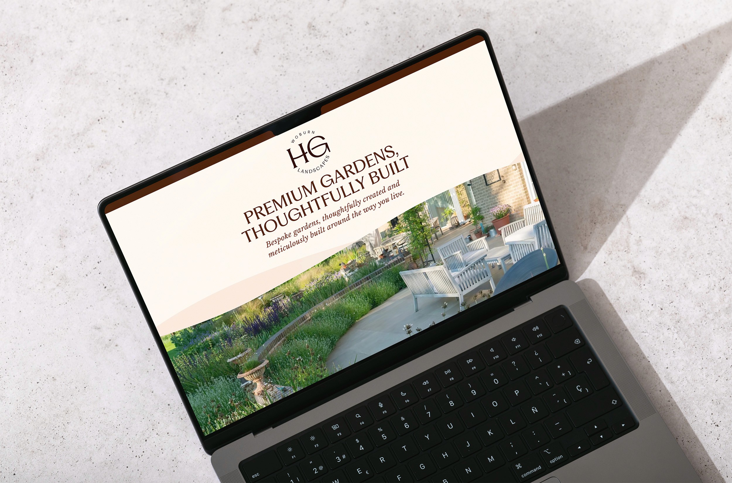 A laptop on a surface displaying a website with a scenic background and clear text.