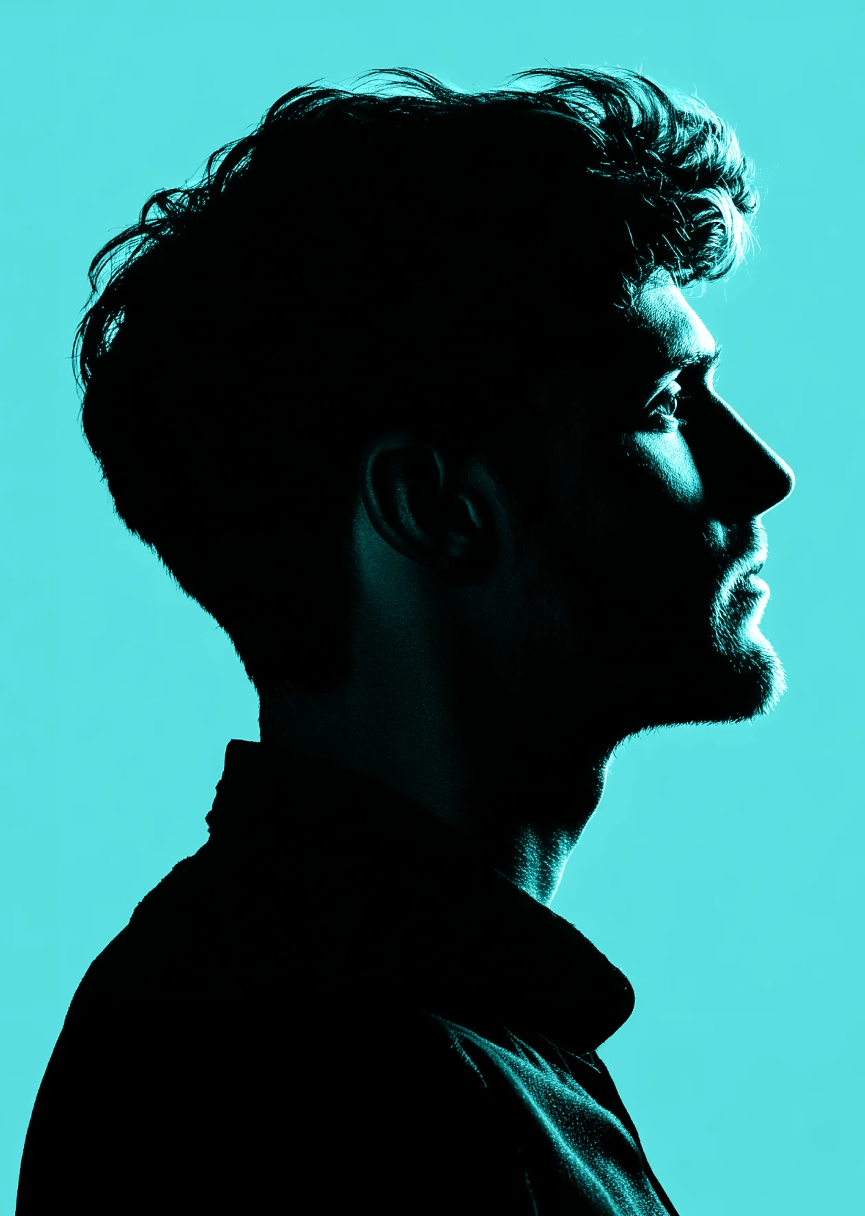 Side profile portrait of Marcus Decker in silhouette against a teal background.