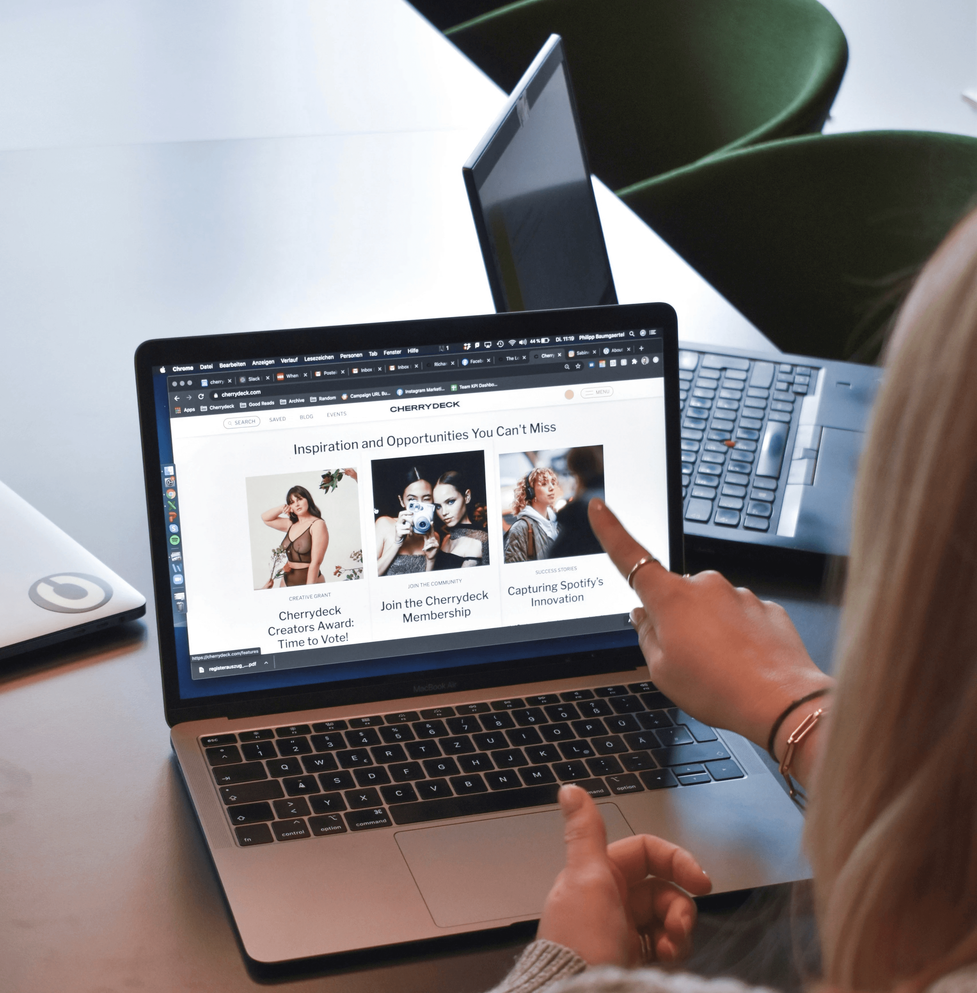 woman in brown sweater using macbook pro