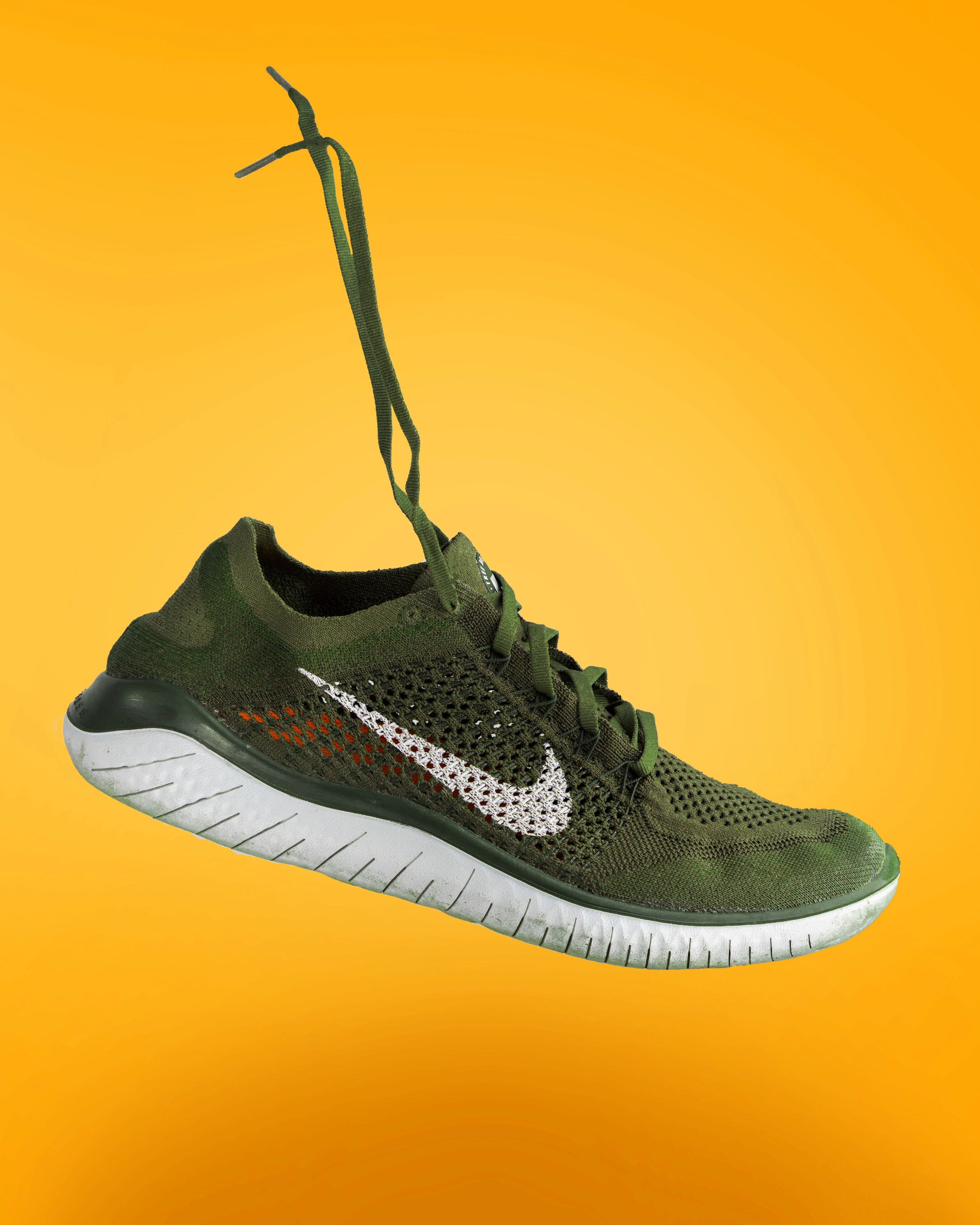 Athletic Nike shoe on a yellow background