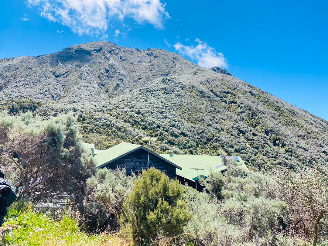 Traditional Arabic setup with chairs and lanterns in the desert sands of AlUla during sunrise.