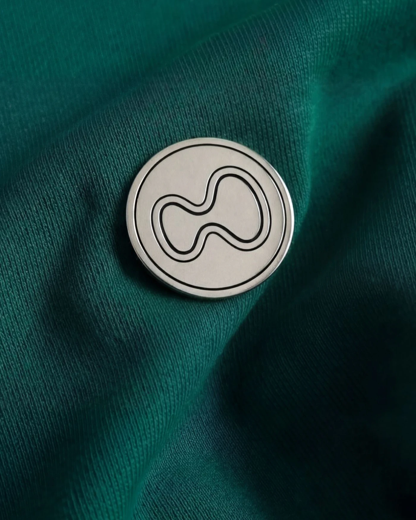 Hyperliquid Policy Center — branded pin on fabric, brand identity by Charlota Blunarova