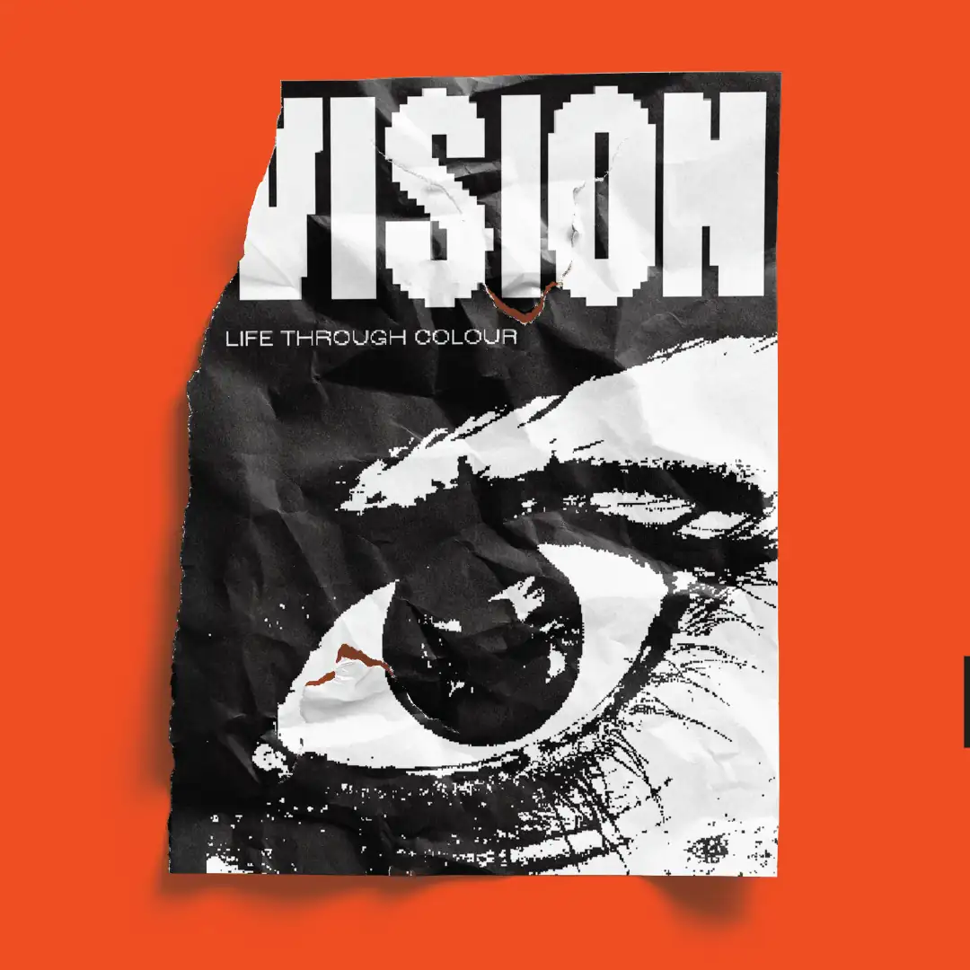 Orange poster reading Vision, life through colour, with a pixelated black and white eye