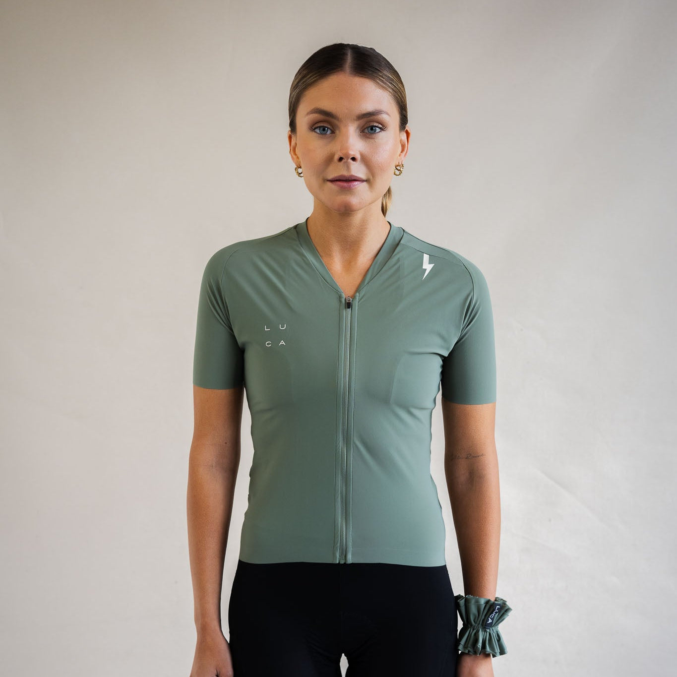 Cyclist wearing LUCA Soleil jersey in matcha, front view