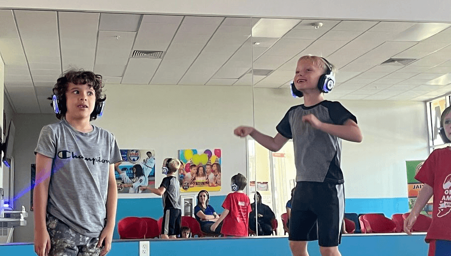 Kids having a silent dance party, while listening to music via headphones.
