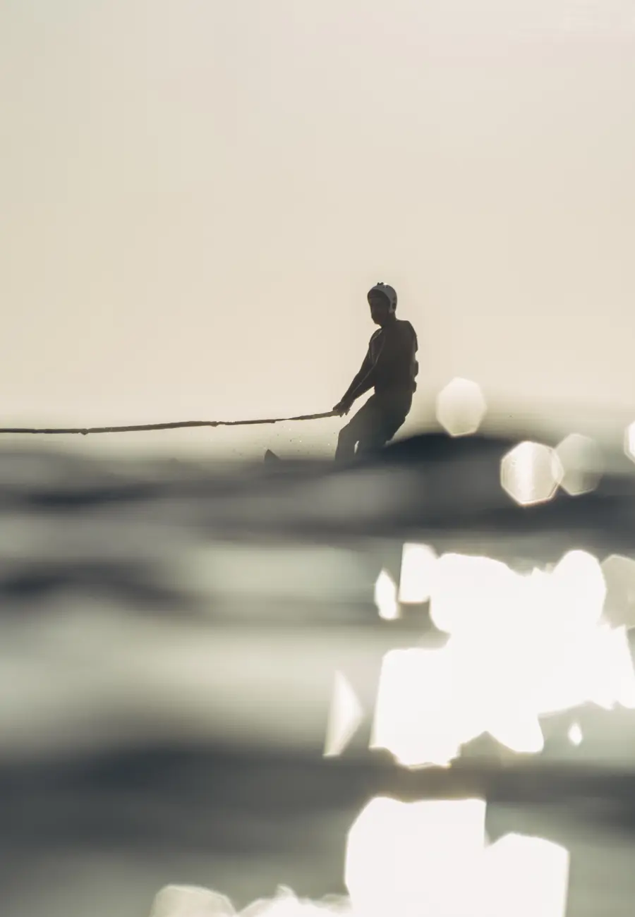 man surfing on sea waves during daytime