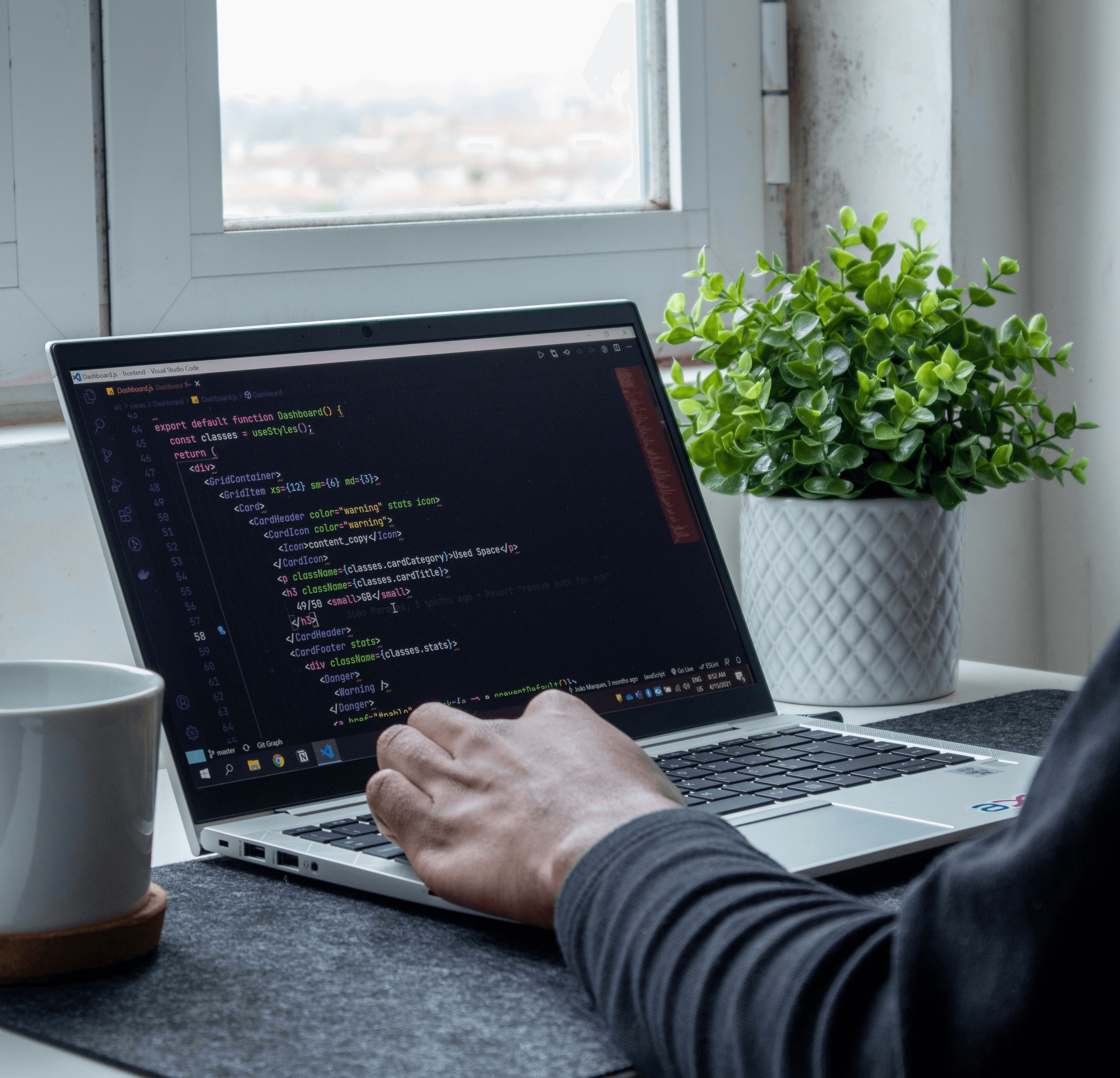 person using macbook pro on table