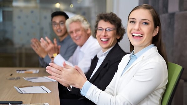 Communication team applauding during a meeting