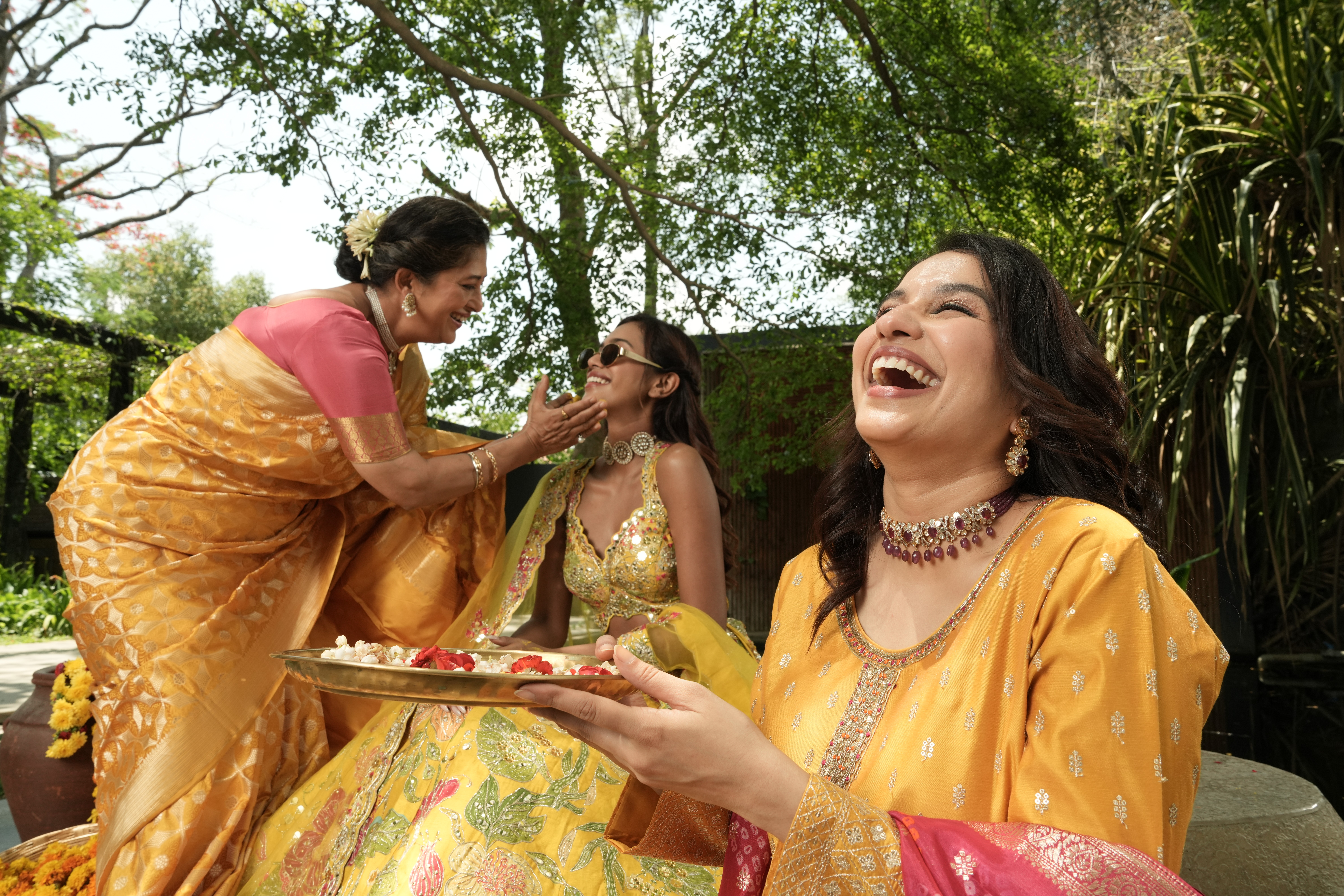 Three women celebrating Haldi ceremony wearing traditional Mysore Saree Udyog (MSU) sarees, showcasing vibrant colors and cultural heritage