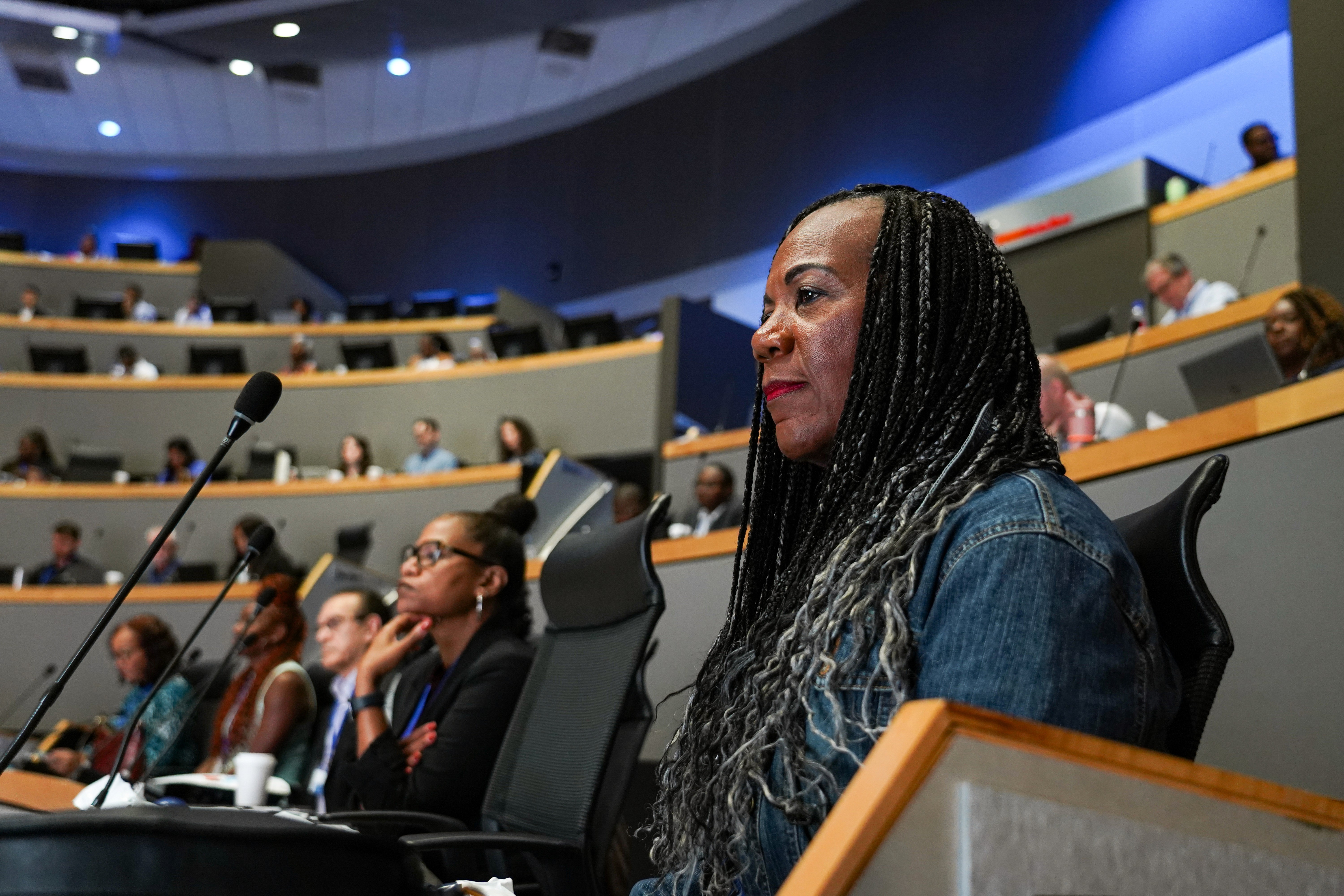 Black cosmetic product bottle against a dark background