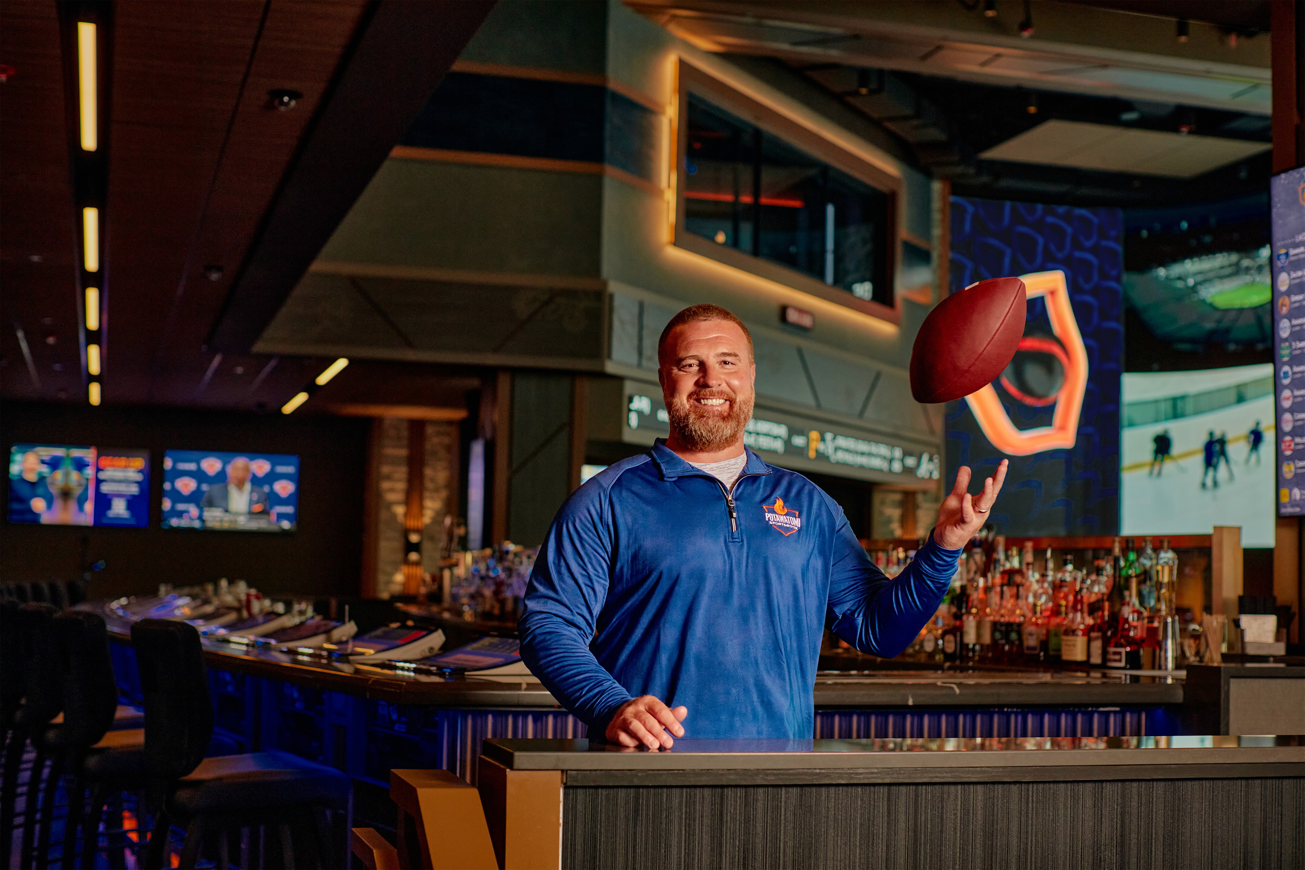 John Kuhn tossing football into air at the Sportsbook