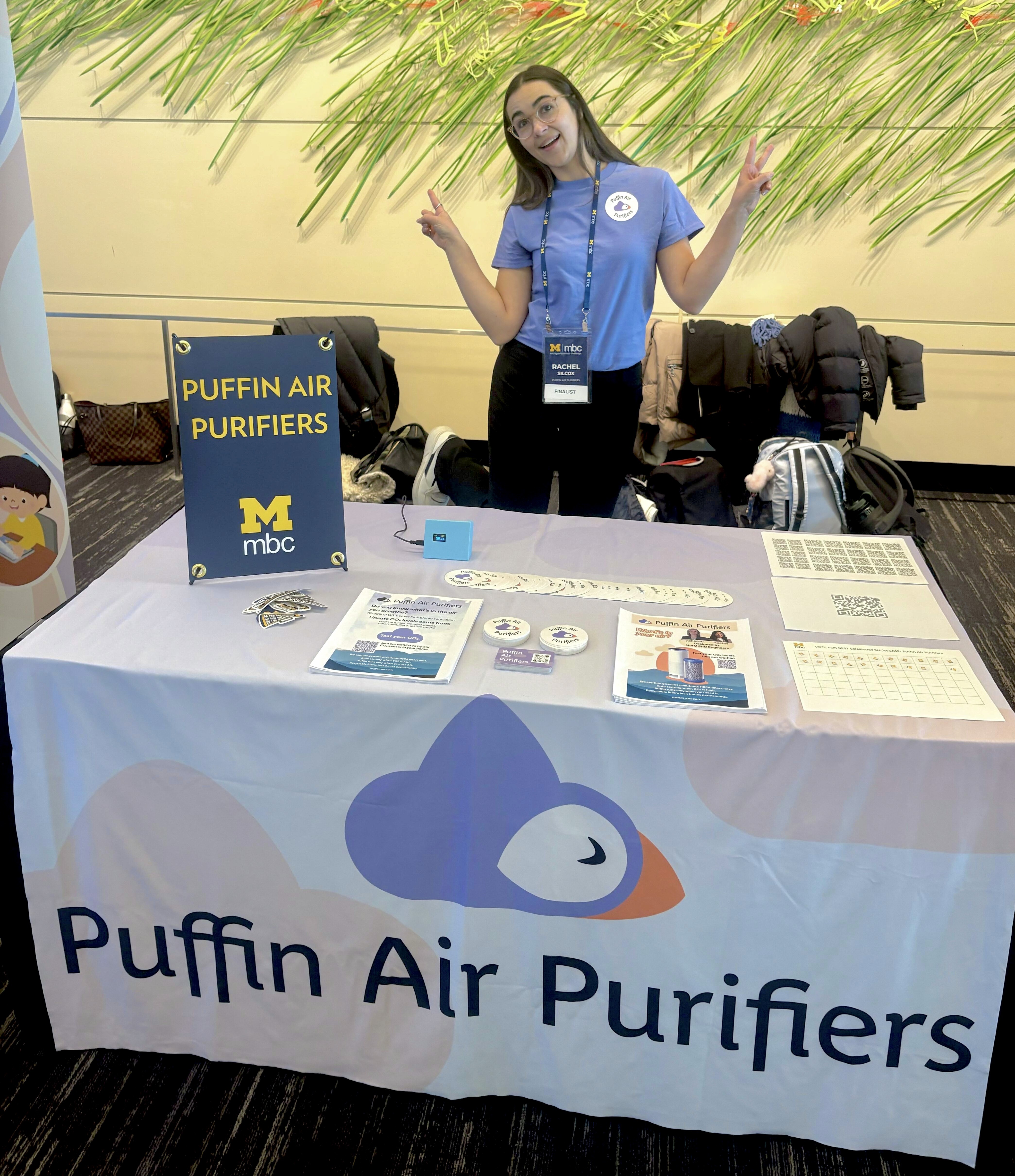 Cofounder posing at Puffin Air Purifiers table