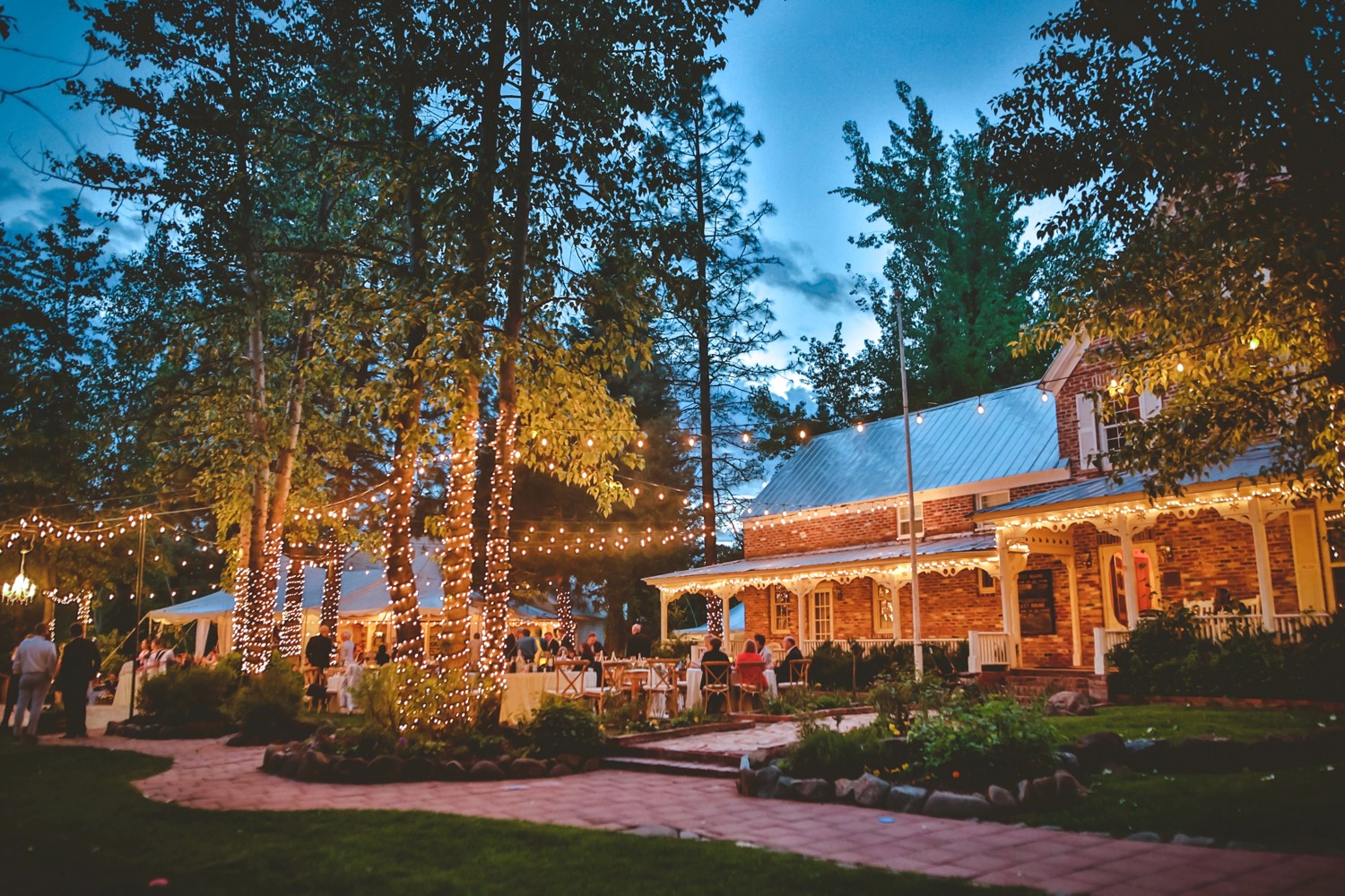 A serene pathway lined with trees leads to a distant building, bathed in warm sunlight.