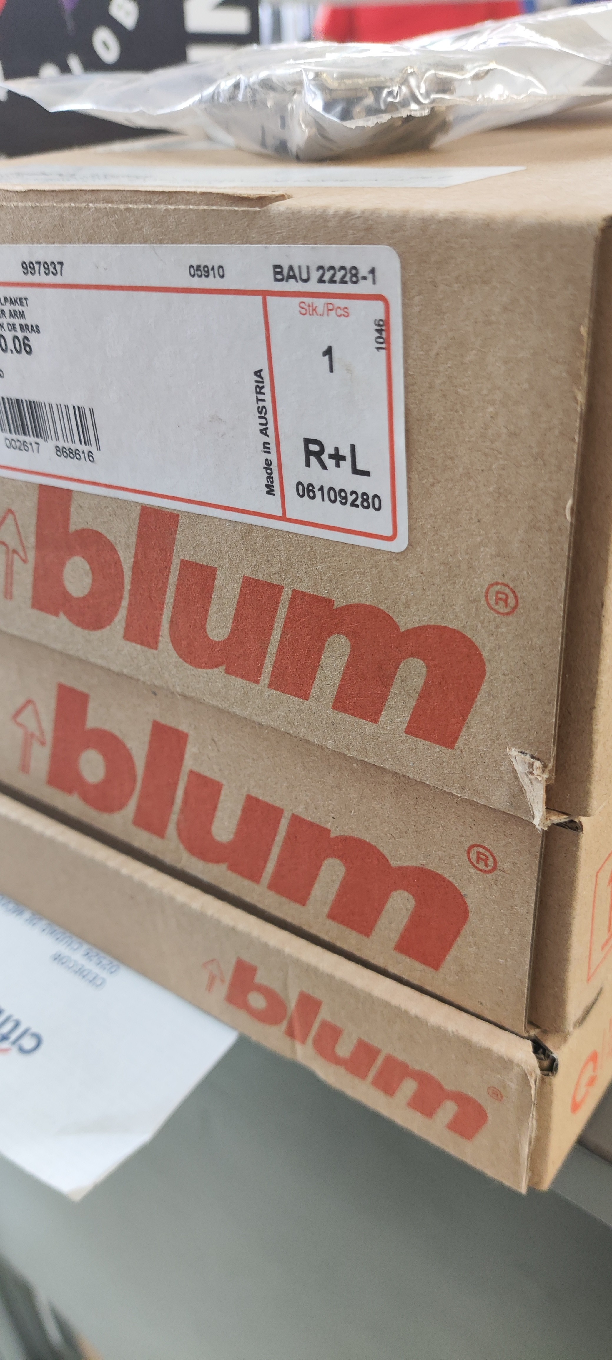 Modern bathroom featuring a walk-in shower, wooden vanity, round mirror, and elegant marble tiles.