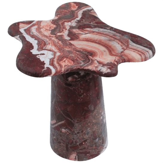 Stone mushroom sculpture table with red, brown and white patterns, resembling a unique natural shape. Artistic stone figurine.