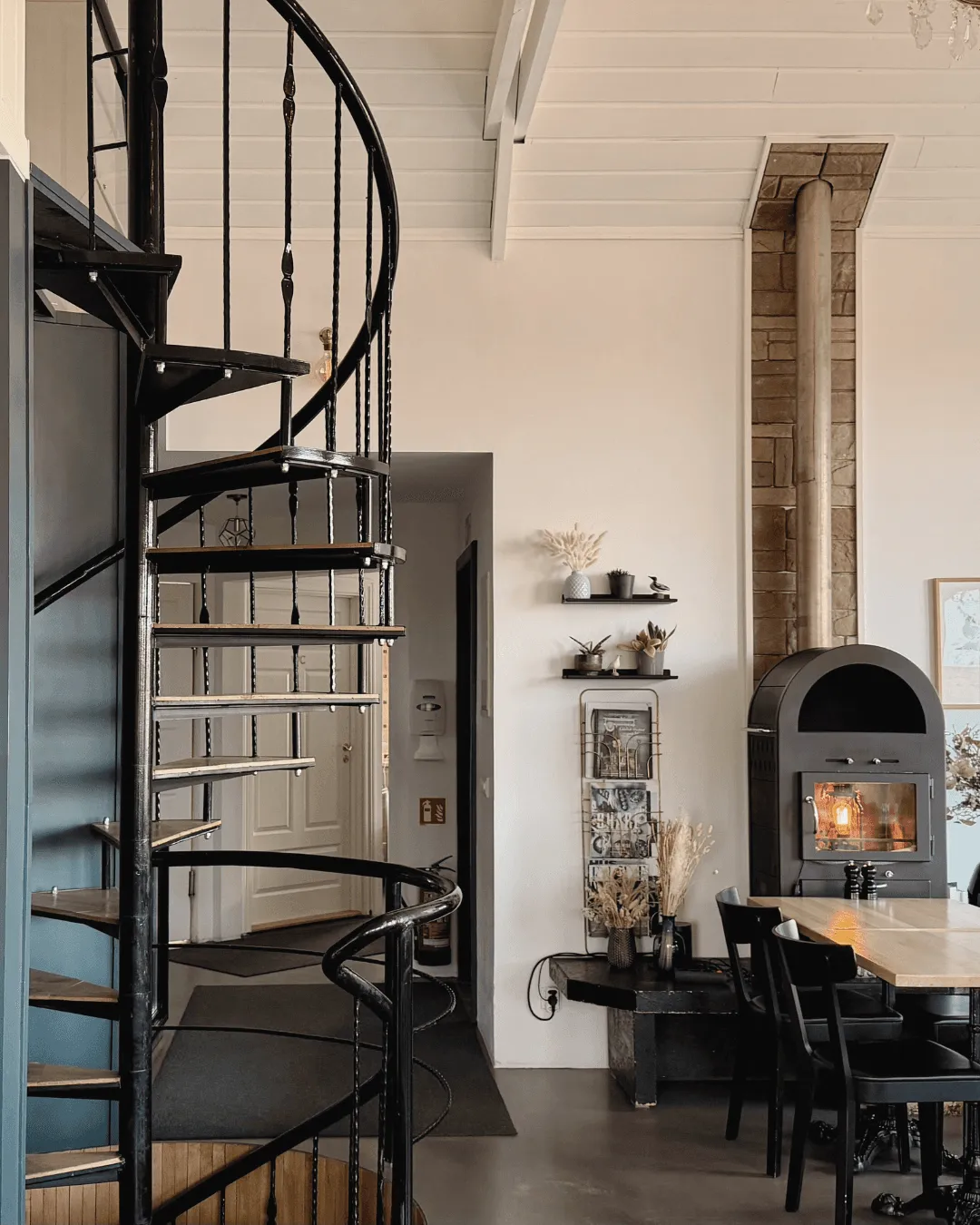 Interior design featuring a black spiral staircase and a modern fireplace