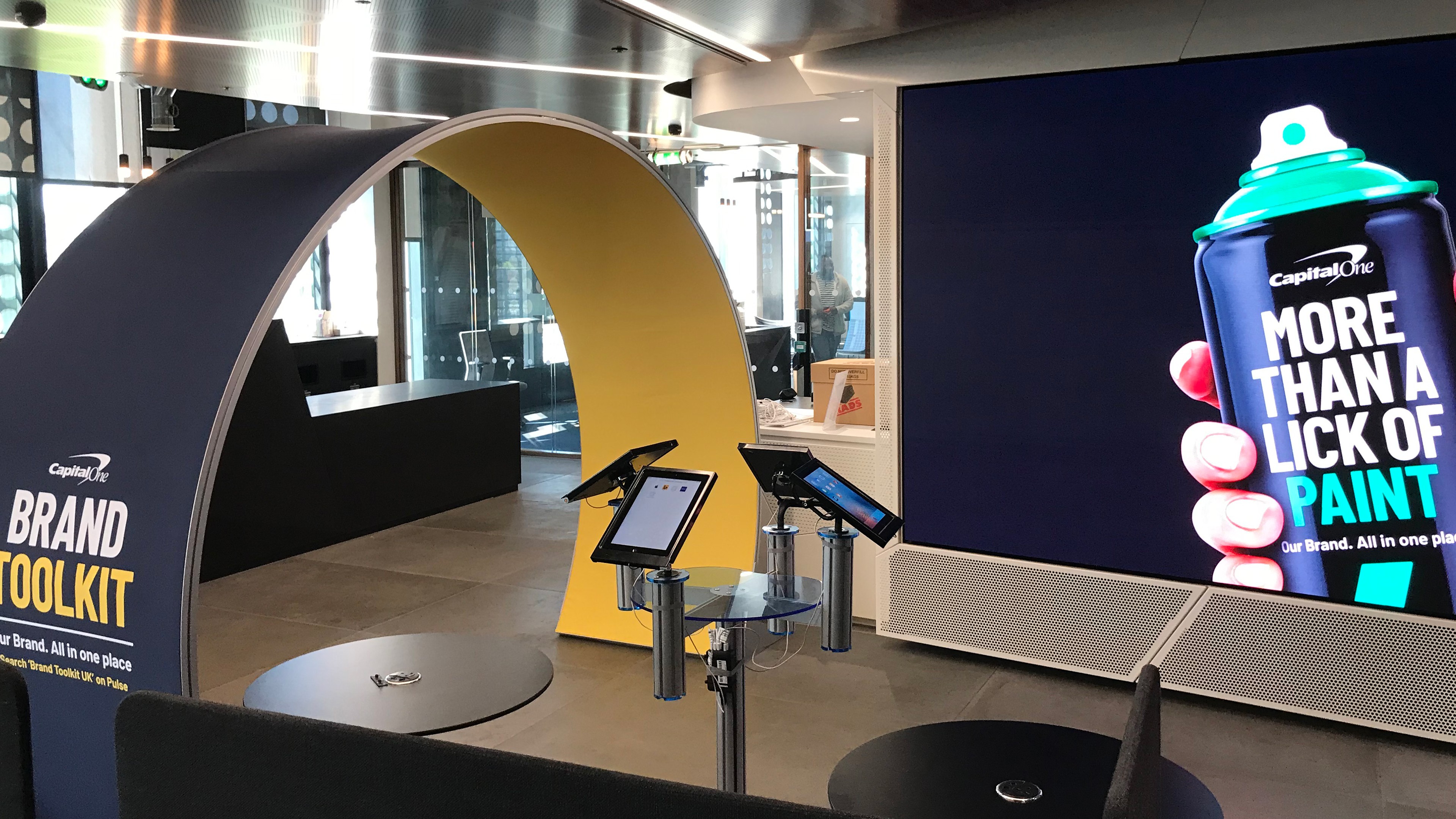 Modern home office setup with a monitor, ergonomic chair, keyboard, and indoor plants near a window with blinds.