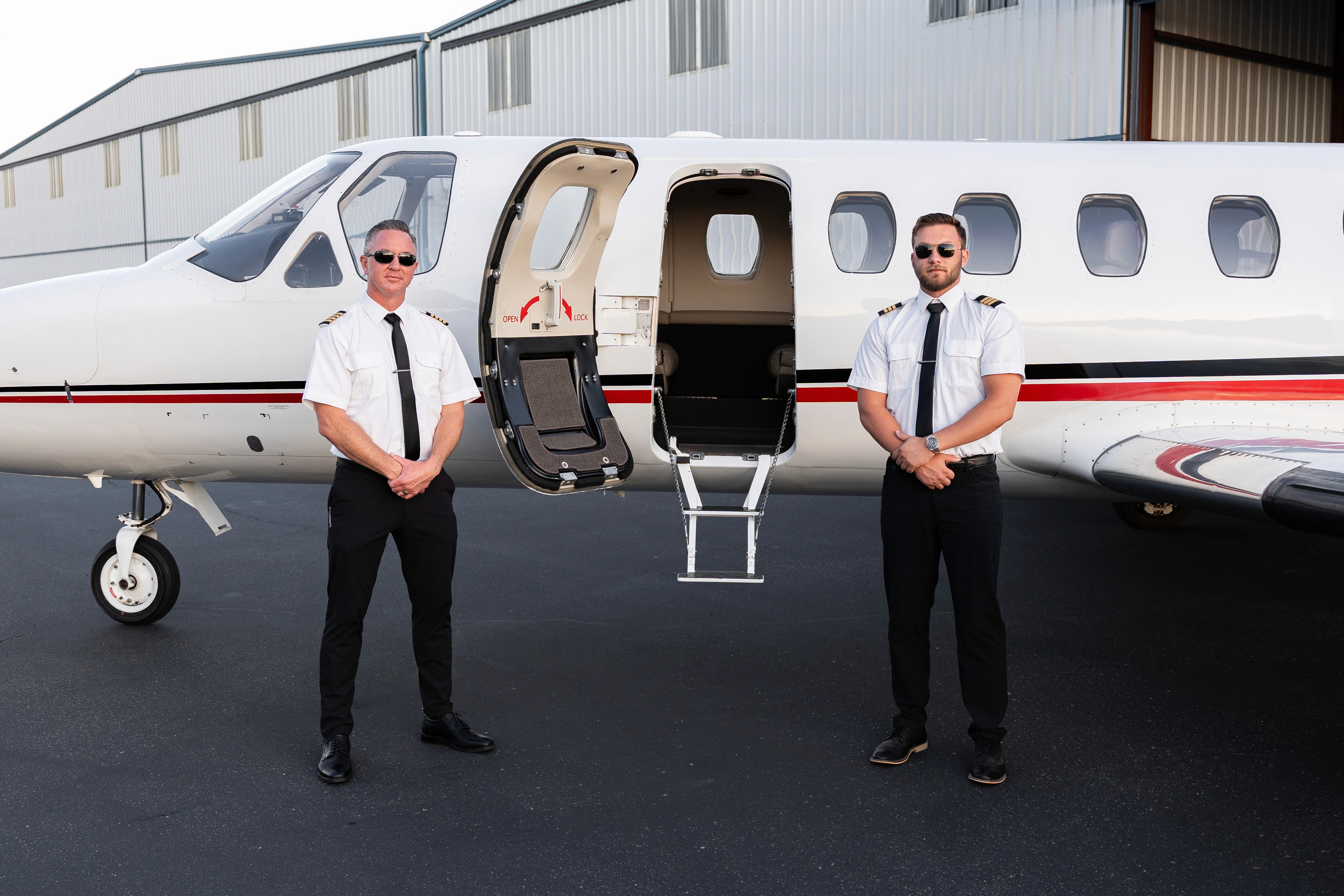A close-up of a black credit card placed on a speckled surface next to a cup of coffee.