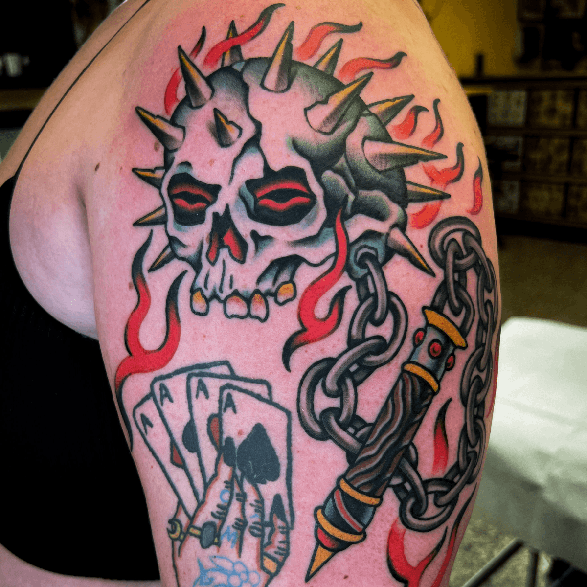 color tattoo of a flail with a skull as the ball