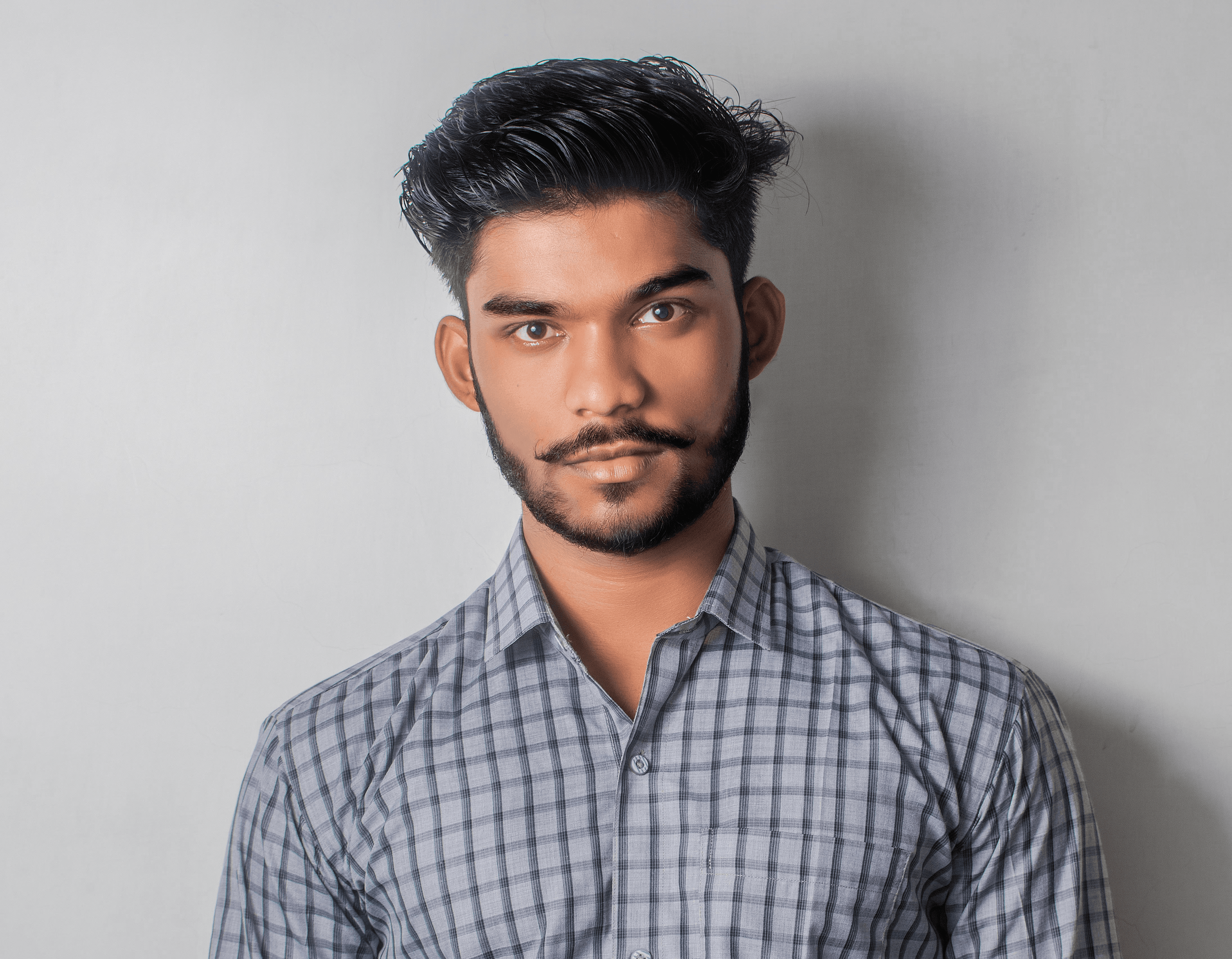 man in gray and black checkered sport shirt and black pants outfit