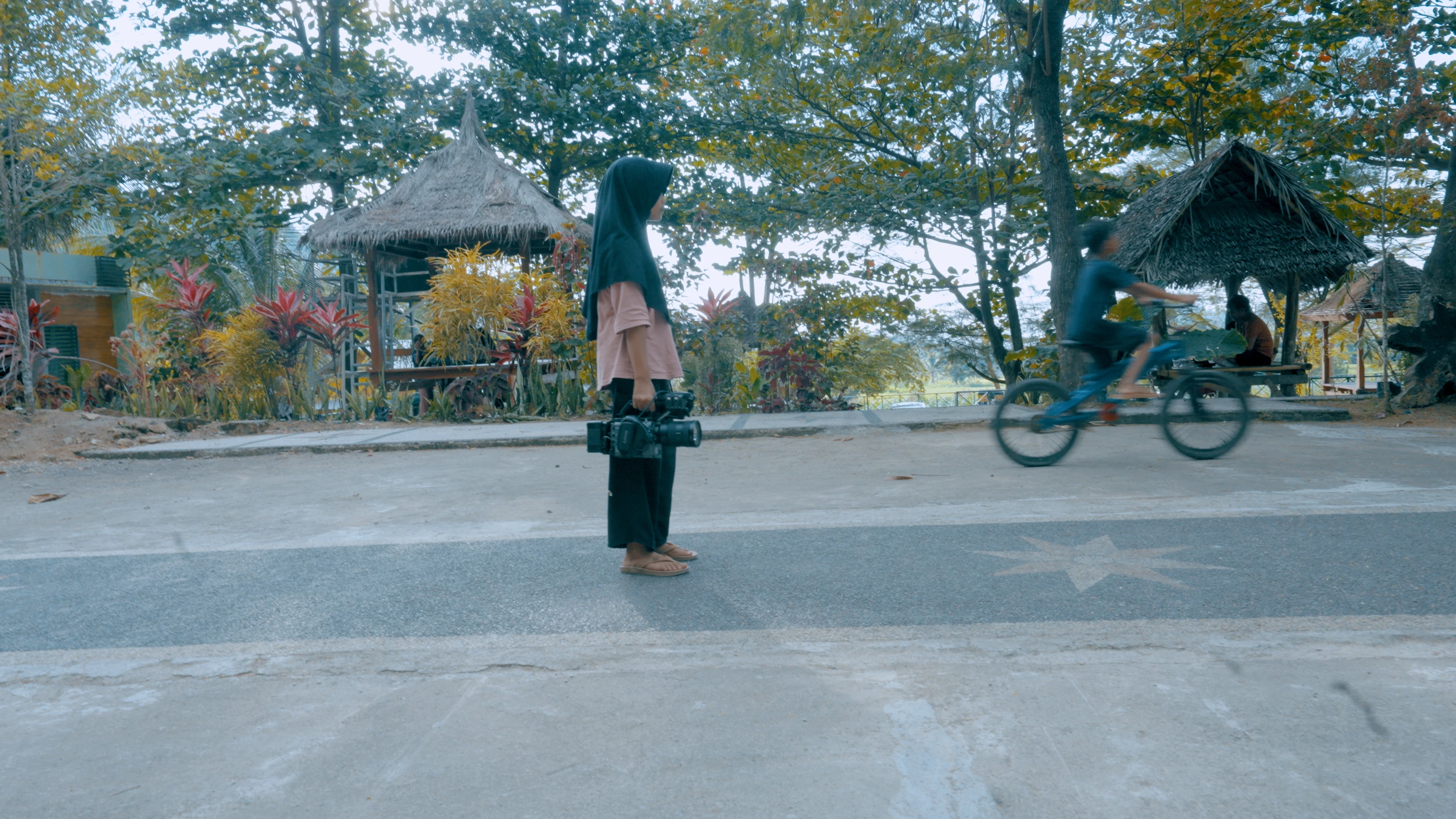 a little girl holds a camera while she learns filming