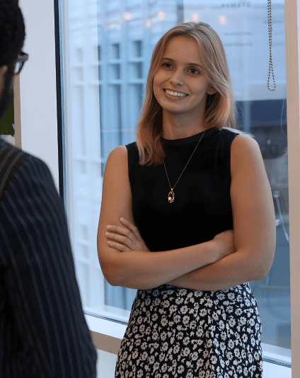 Smiling legal professional in conversation during a meeting, representing collaboration and confidence in a modern legal environment.