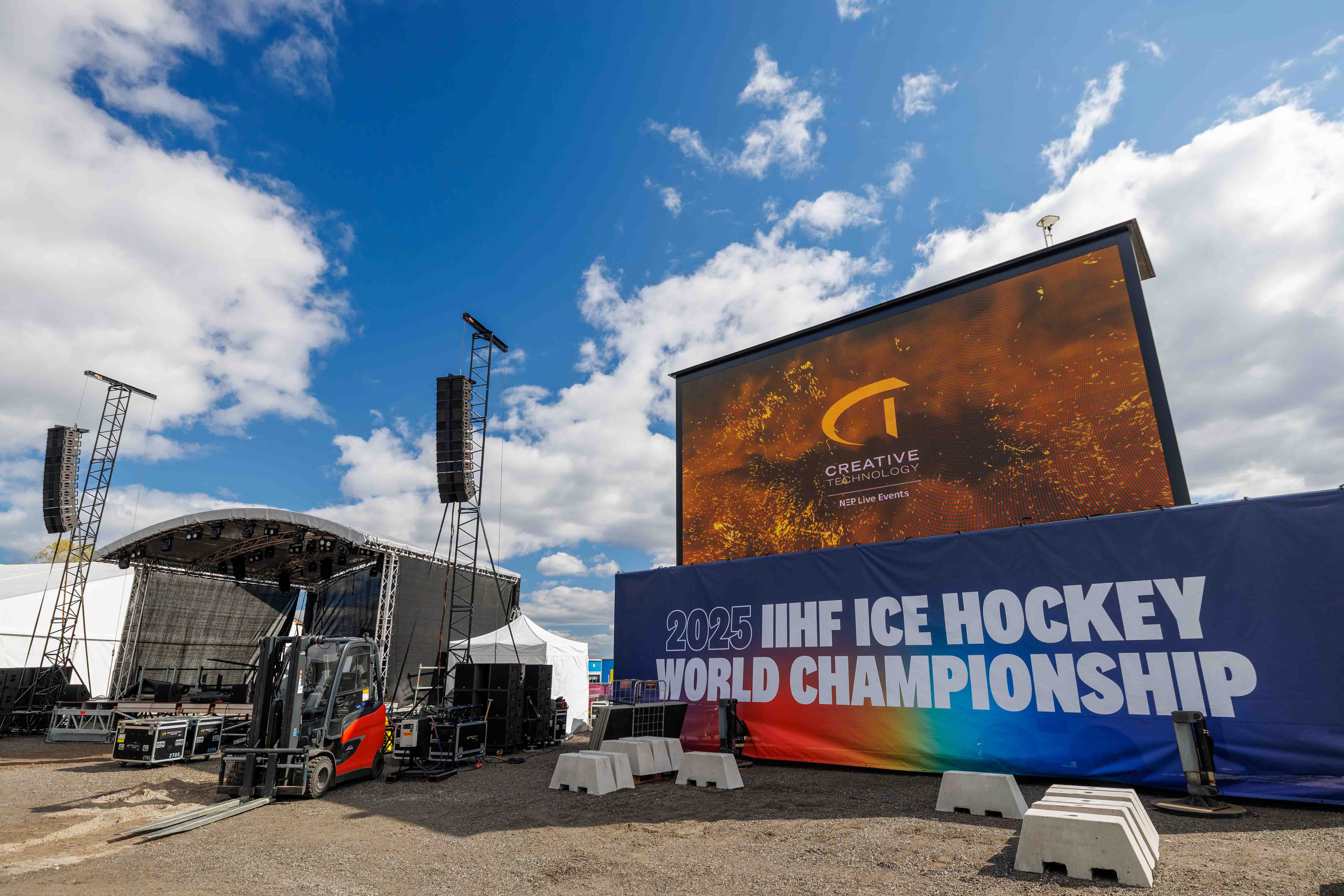 Behind-the-scenes look at the LED screen structure and PA system during the IIHF 2025 Ice Hockey World Championship production by Creative Technology.