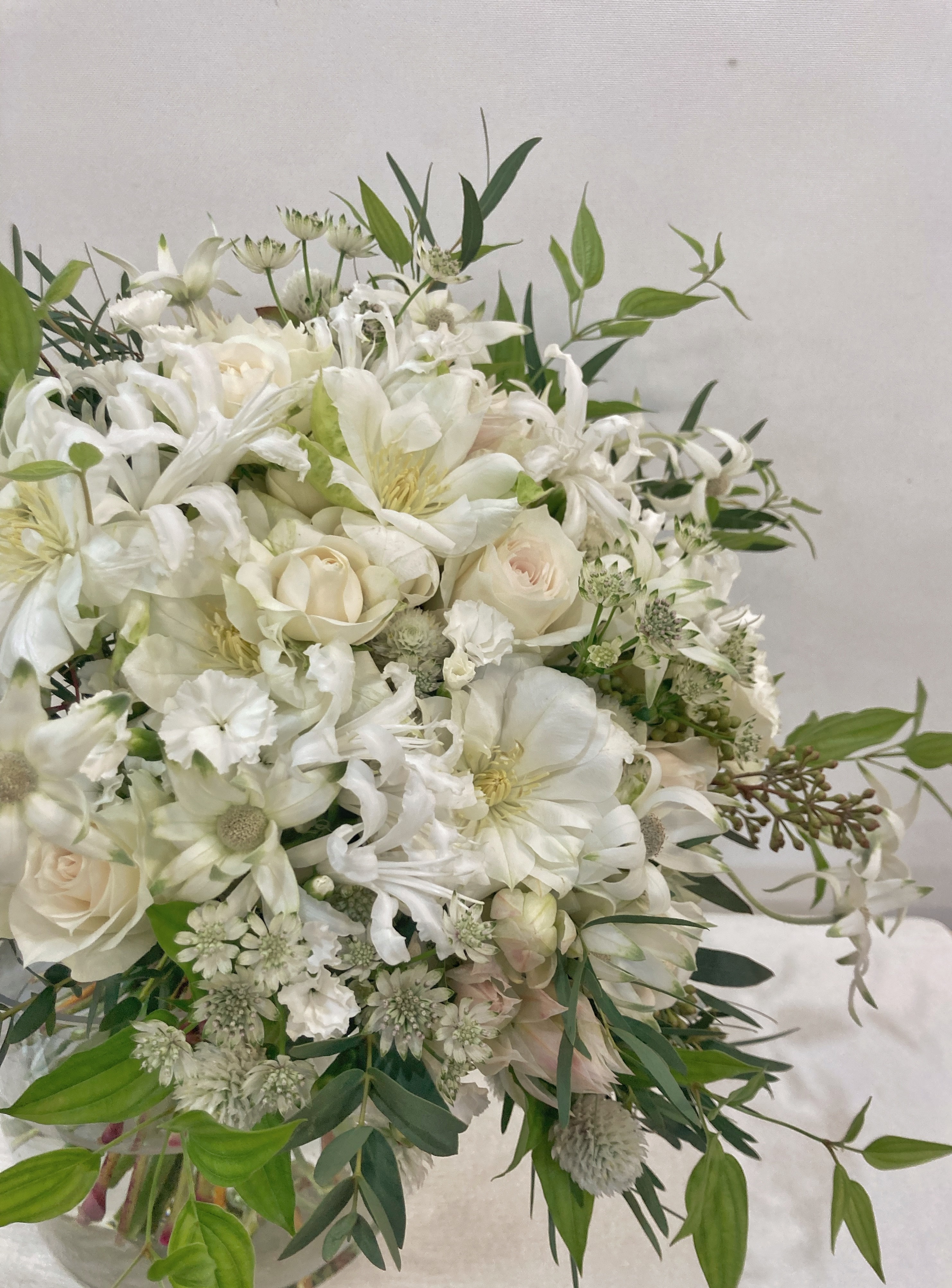 A close up of a person holding a bouquet of flowers