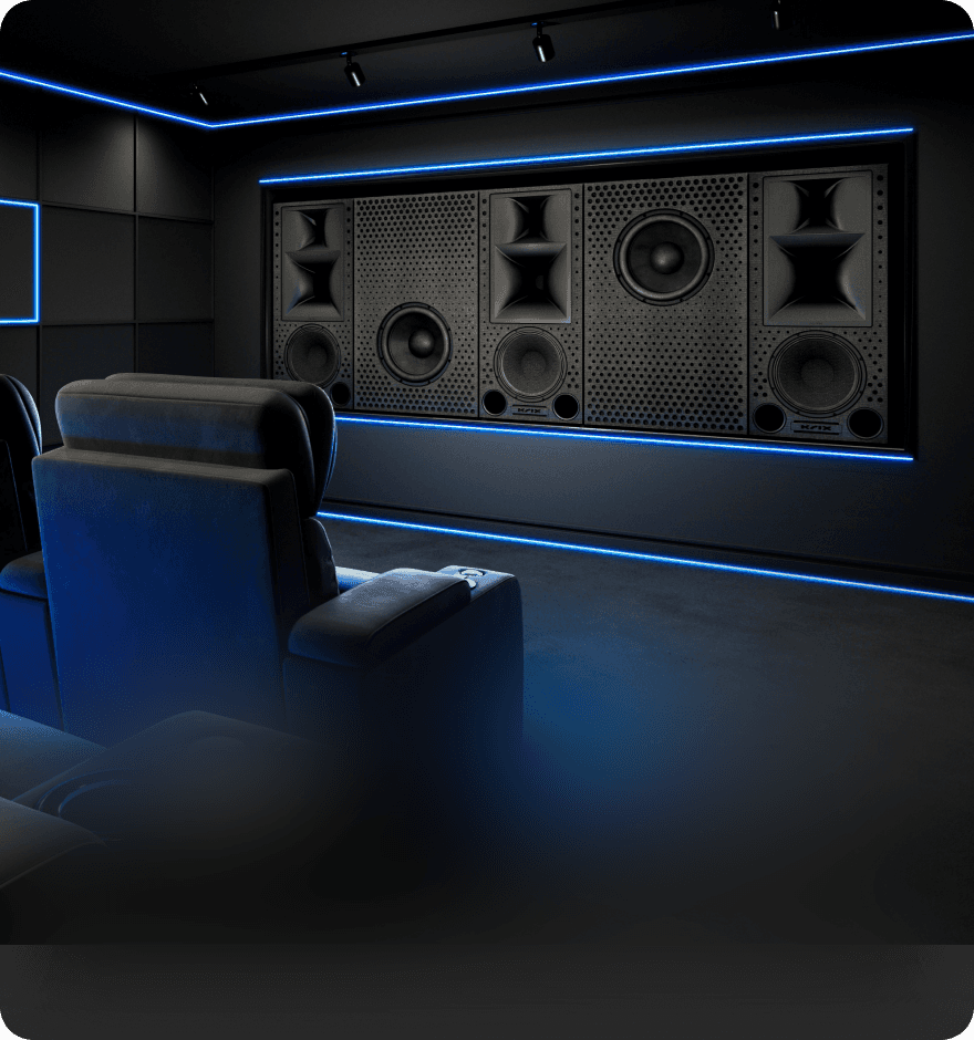 Luxury home theater with large speakers and plush seating, lit by blue LEDs.