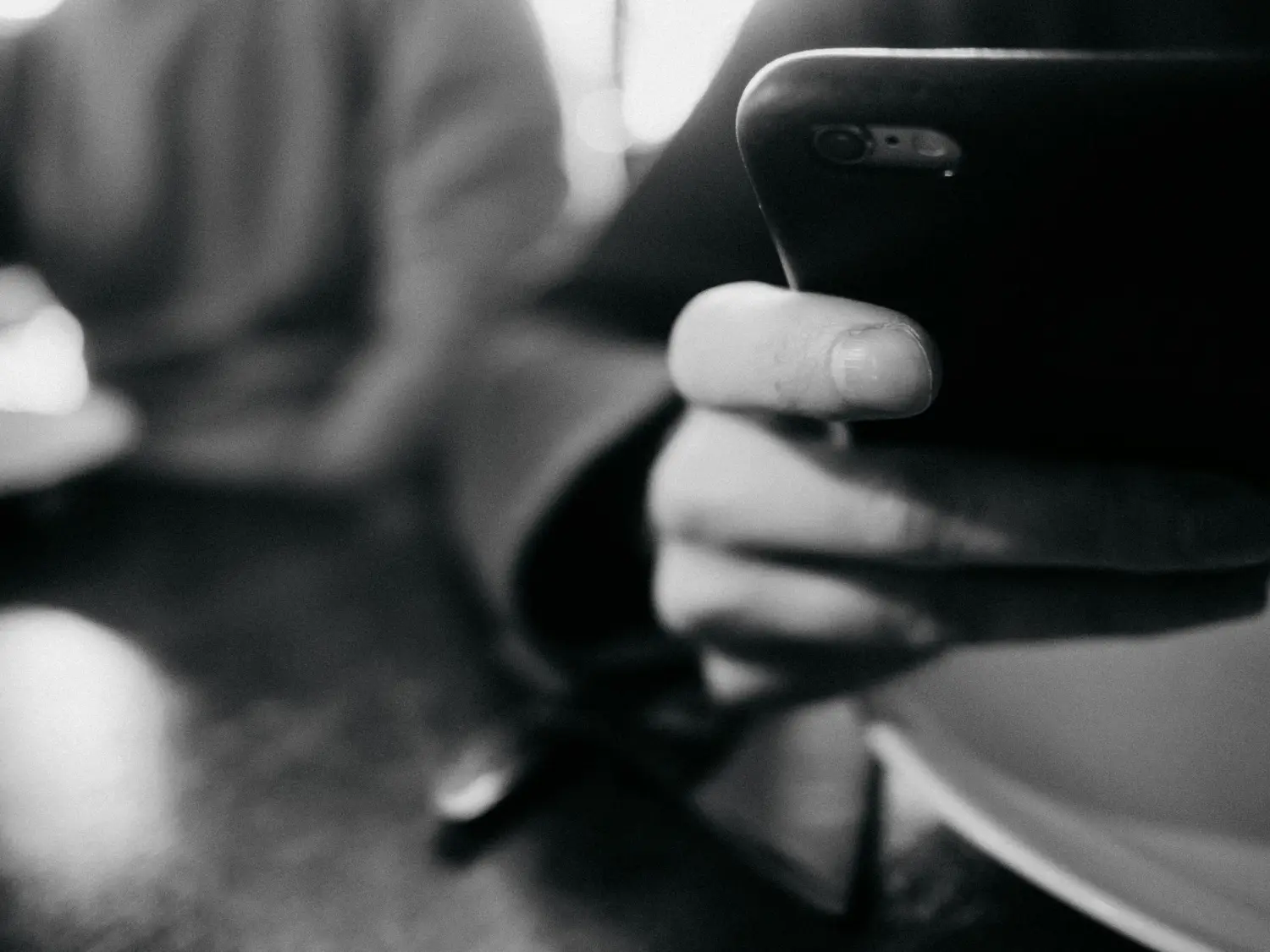 A silhouetted astronaut stands before a glowing portal in a misty, green-lit environment, with their reflection visible in a puddle.