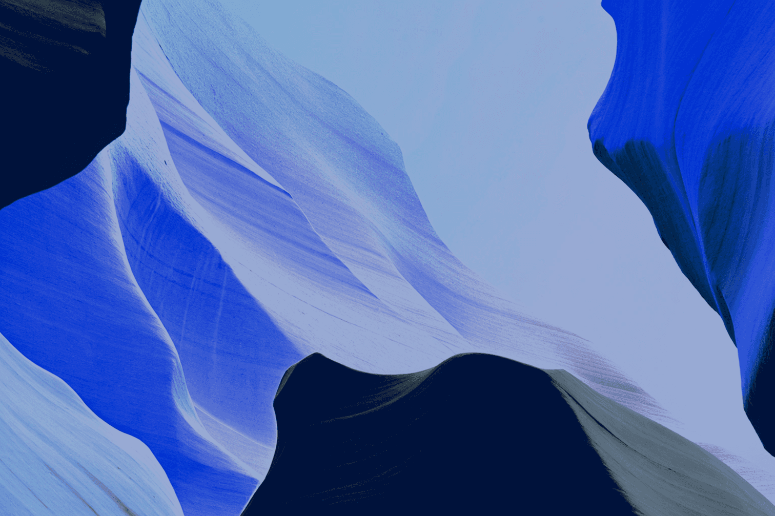 Abstract artwork featuring flowing shapes in various shades of blue against a dark background.