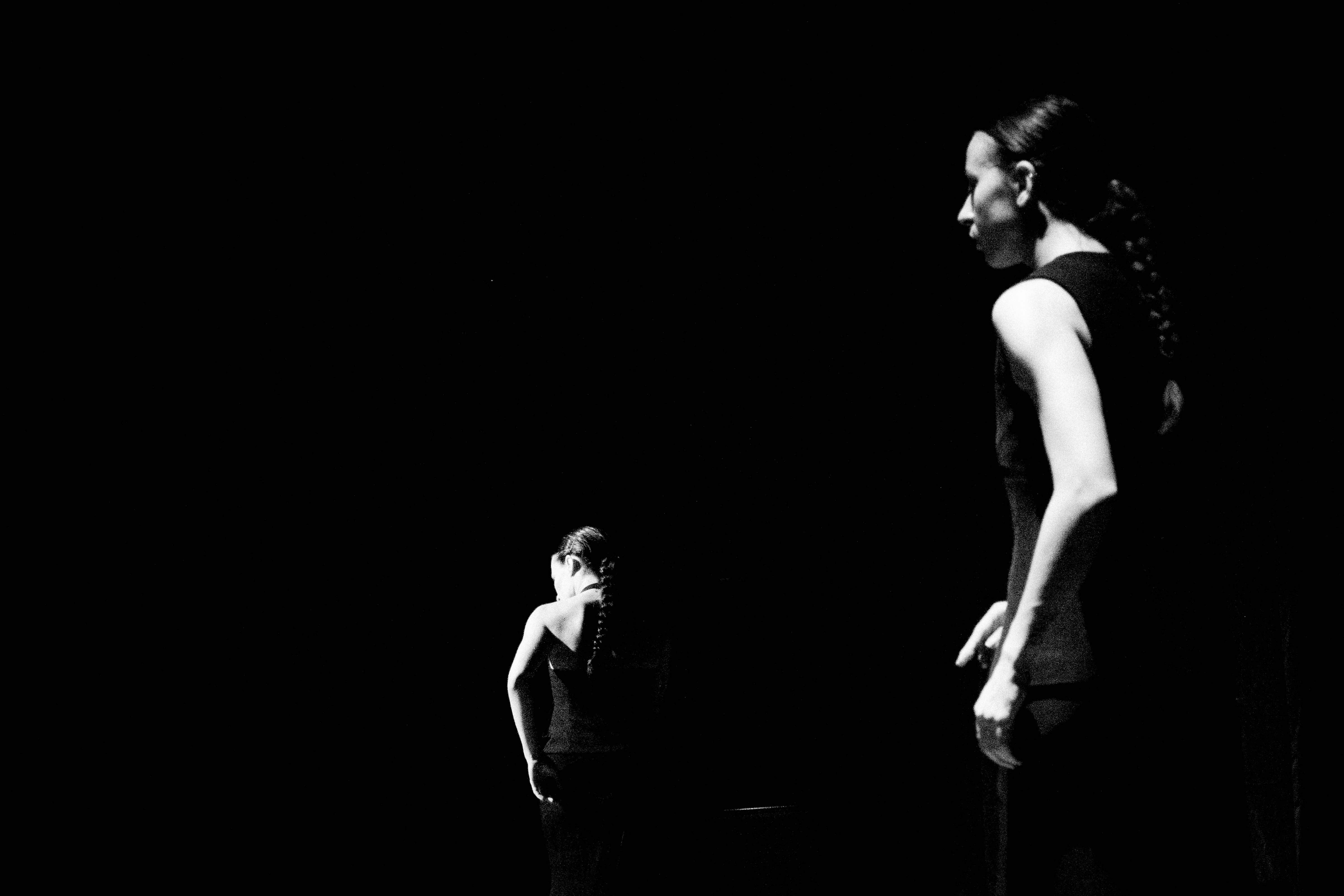 A man working on his computer in a dimly lit office space.