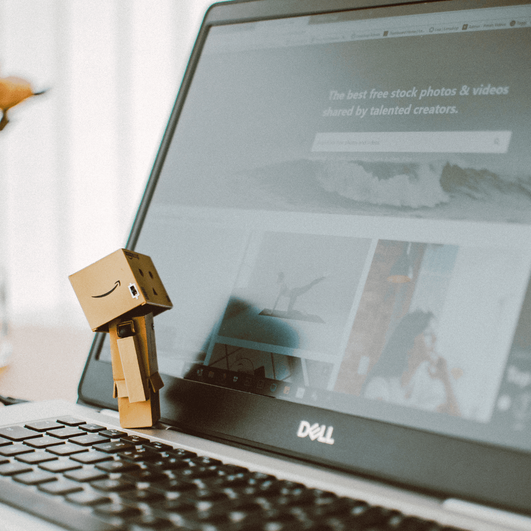 man in green and yellow striped shirt holding black smartphone
