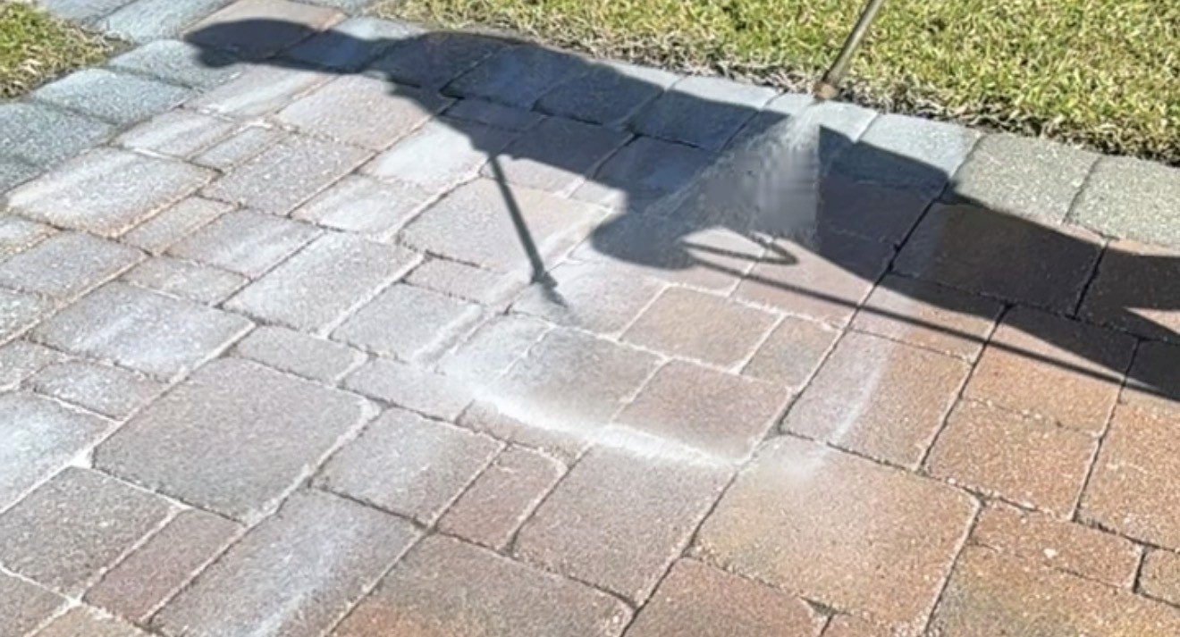 Picture of technician sealing pavers 