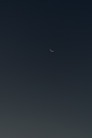 Dark blue sky with small crescent moon