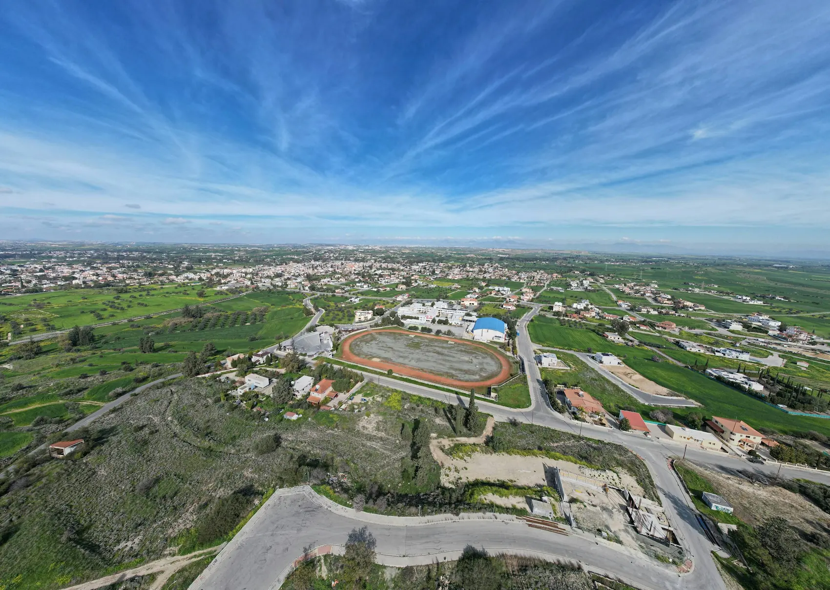 Aerial drone shot of a town and stadium designed for real estate virtual tours