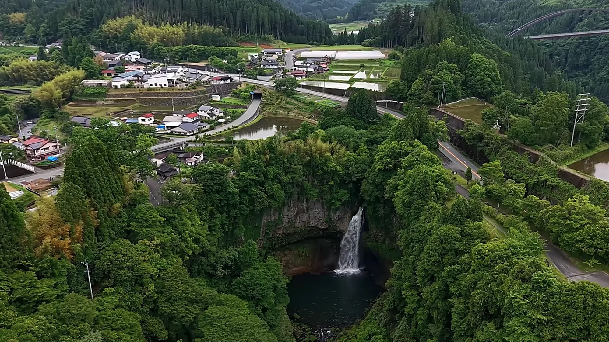 Aerial view of the village, terraces and a waterfall at Kurokawa Onsen