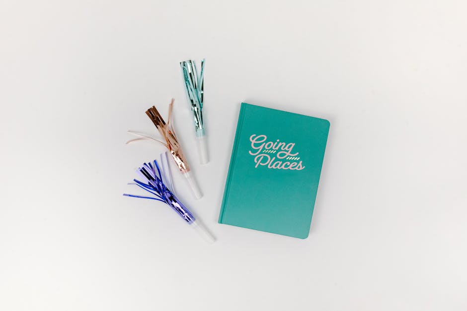 A teal journal titled 'Going Places' paired with colorful party blowers on a white background.